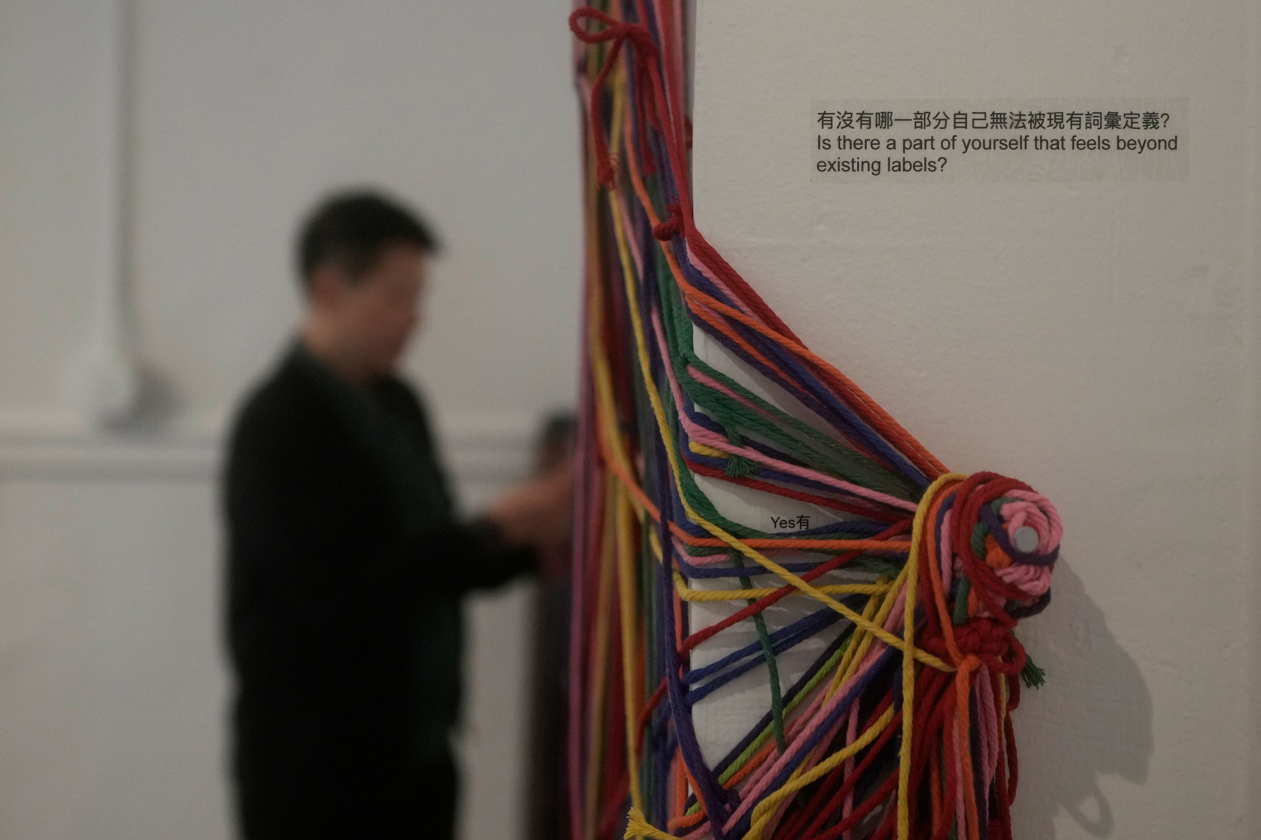 OUT Museum founder Xiangqi Chen looks toward “Collective Notation,” an interactive installation displayed at the Chinatown museum, Monday, June 22, 2026, in San Francisco. (AP Photo/Jeff Chiu)
