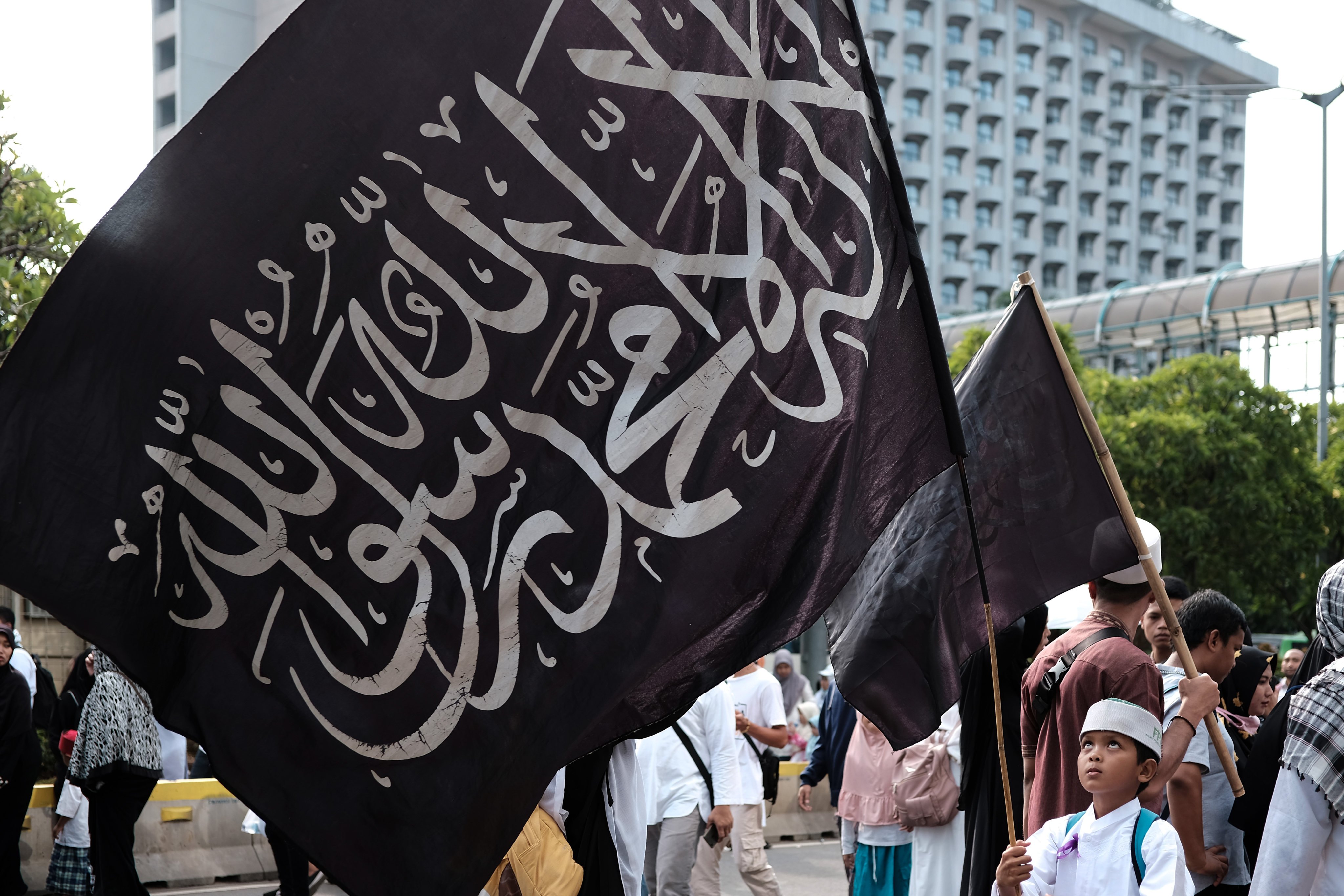 A boy waves a flag at a rally attended by thousands of Indonesian Islamists in Jakarta in 2018. Photo: AFP