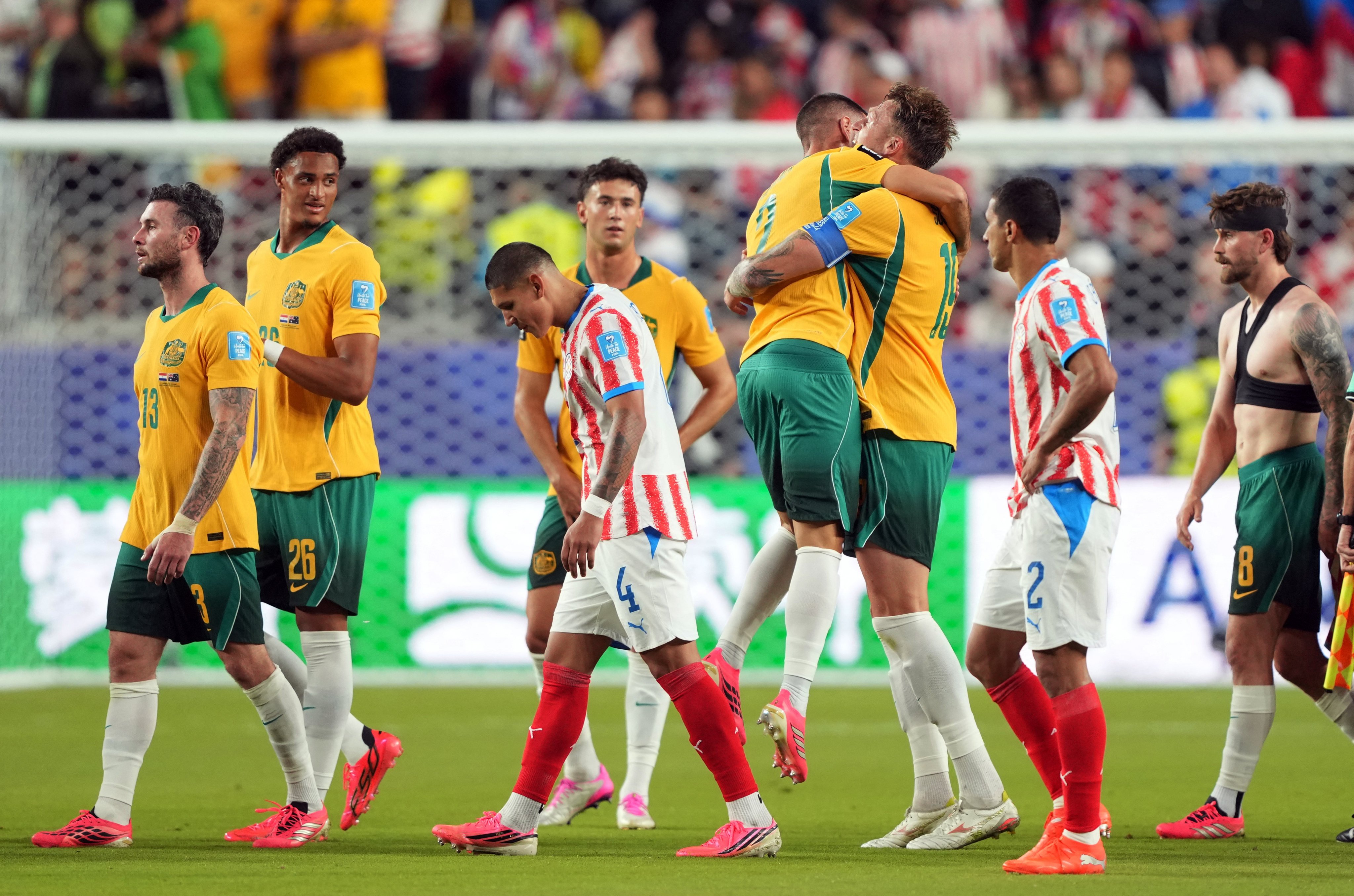 Australia’s Milos Degenek (left) and Harry Souttar celebrate advancing as runners-up in Group D after the match against Paraguay. Photo: Reuters