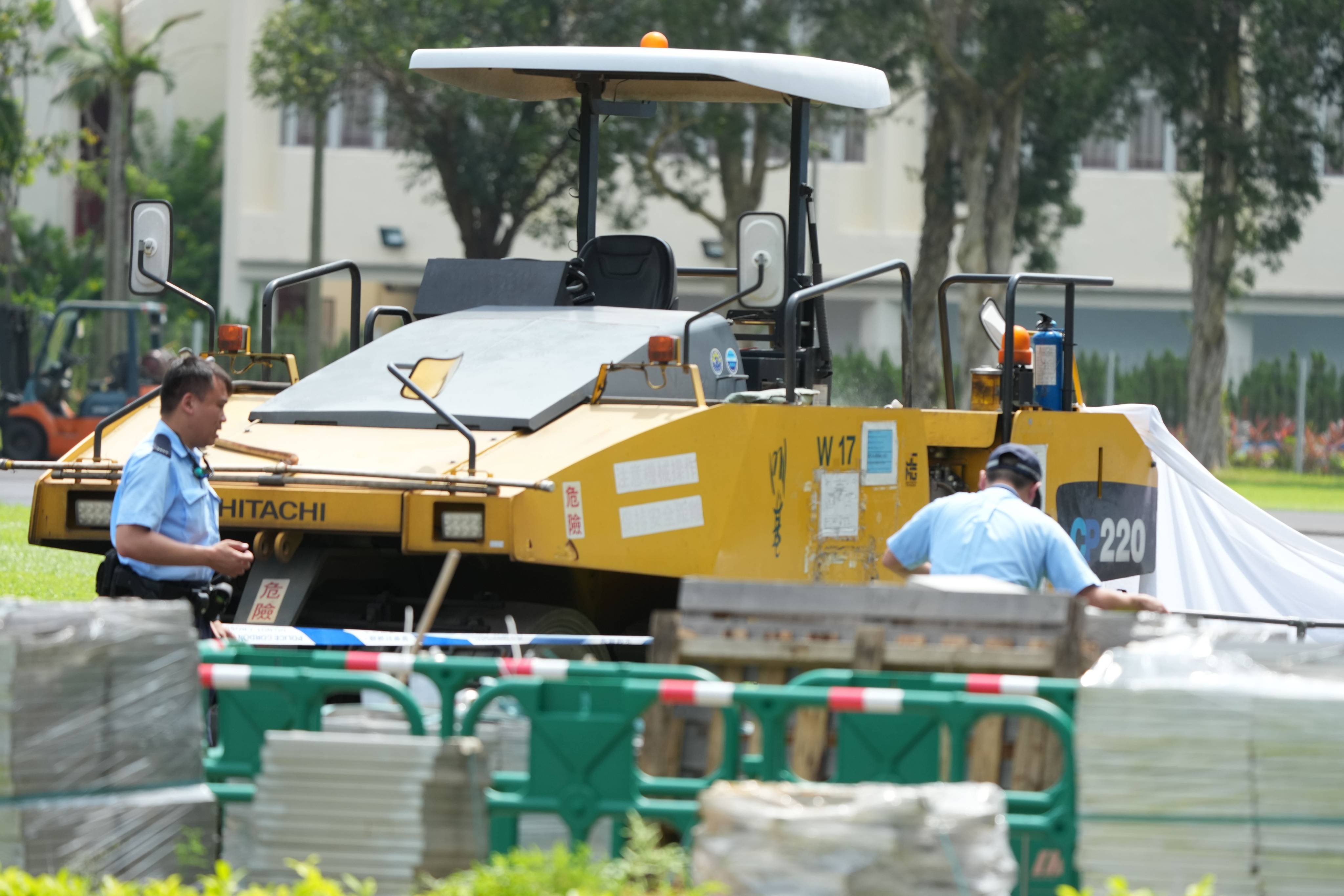 Investigators inspect the scene at Kowloon Bay Sports Ground, where a worker died after being run over by a construction vehicle on June 26. Photo: Dickson Lee