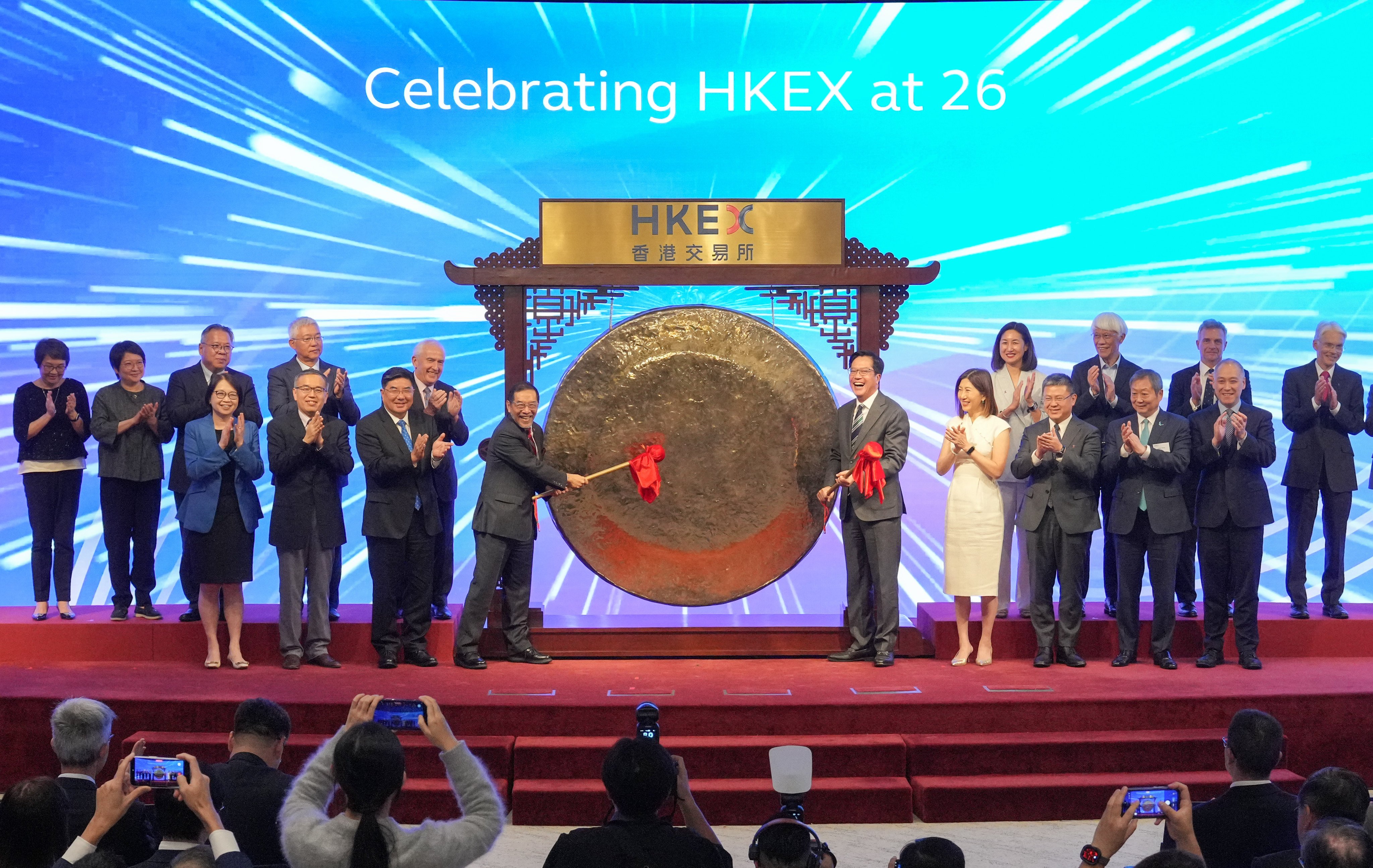 HKEX chairman Carlson Tong and Deputy Financial Secretary Michael Wong strike the gong to mark the bourse operator’s 26th anniversary. Photo: May Tse