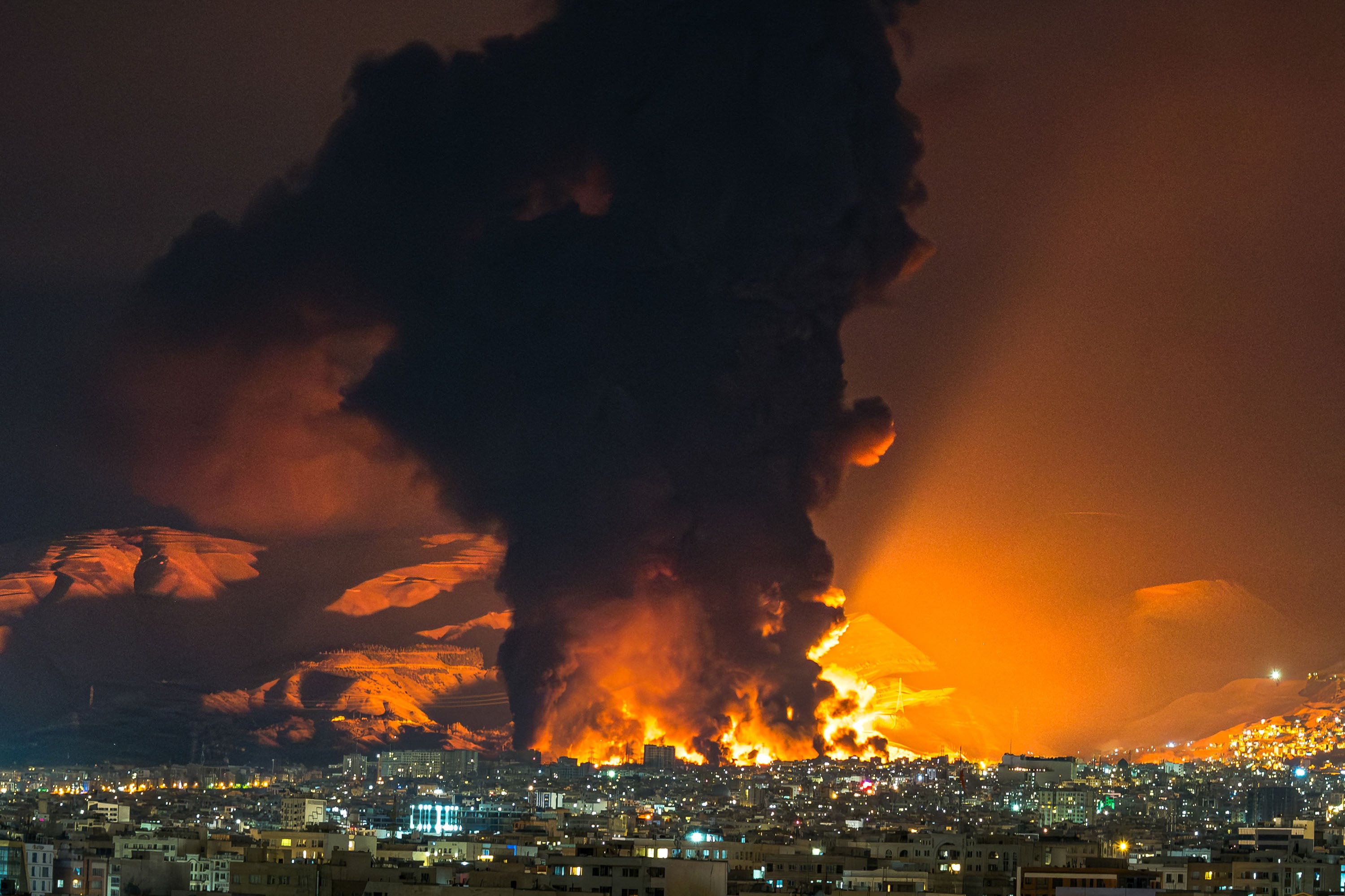Smoke and flames rise from the site of US-Israeli airstrikes on an oil depot in Tehran on March 7. Photo: Sasan/Middle East Images/AFP/Getty Images/TNS