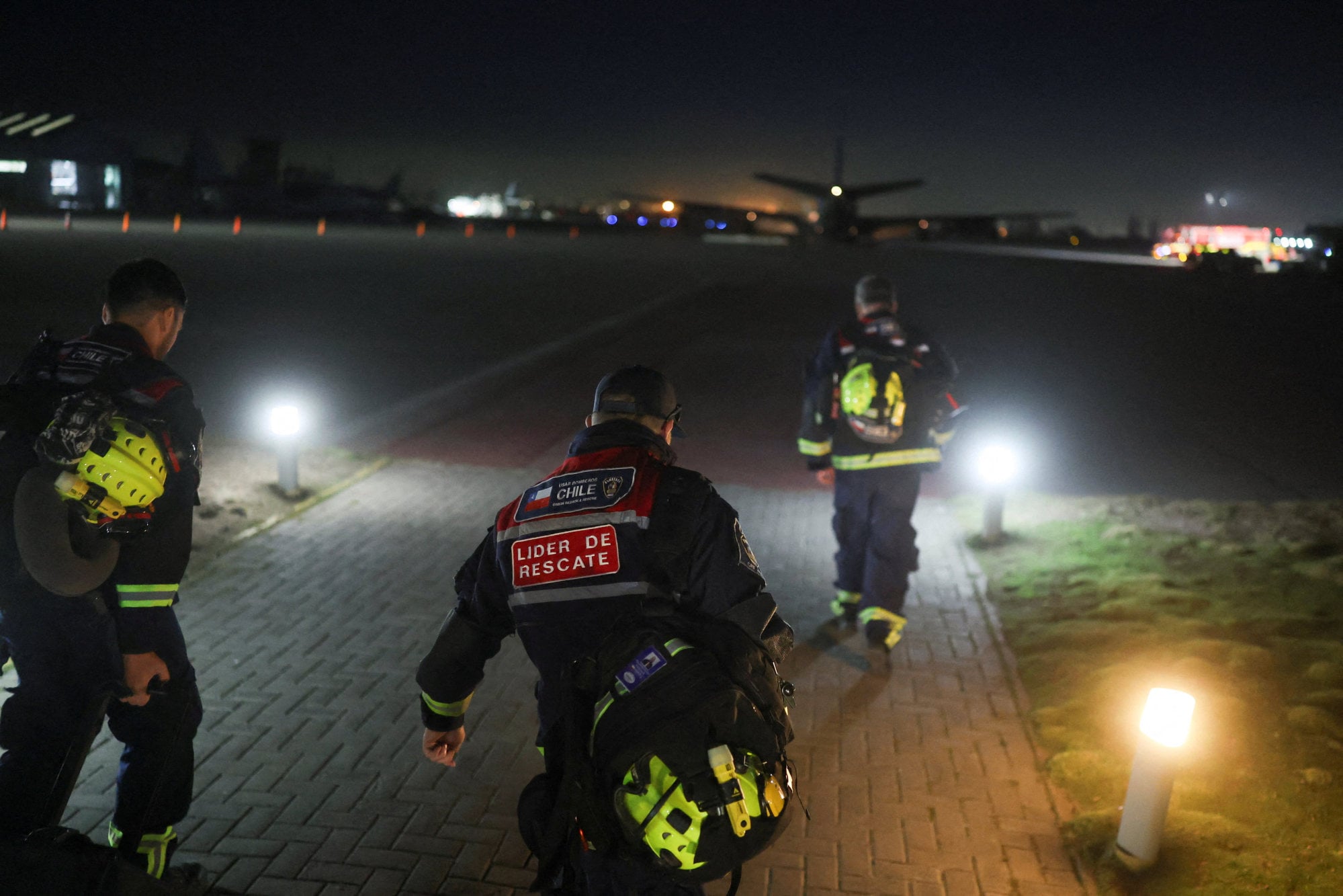 Members of a specialised unit of the Chilean fire department, bound for Venezuela. Photo: Reuters