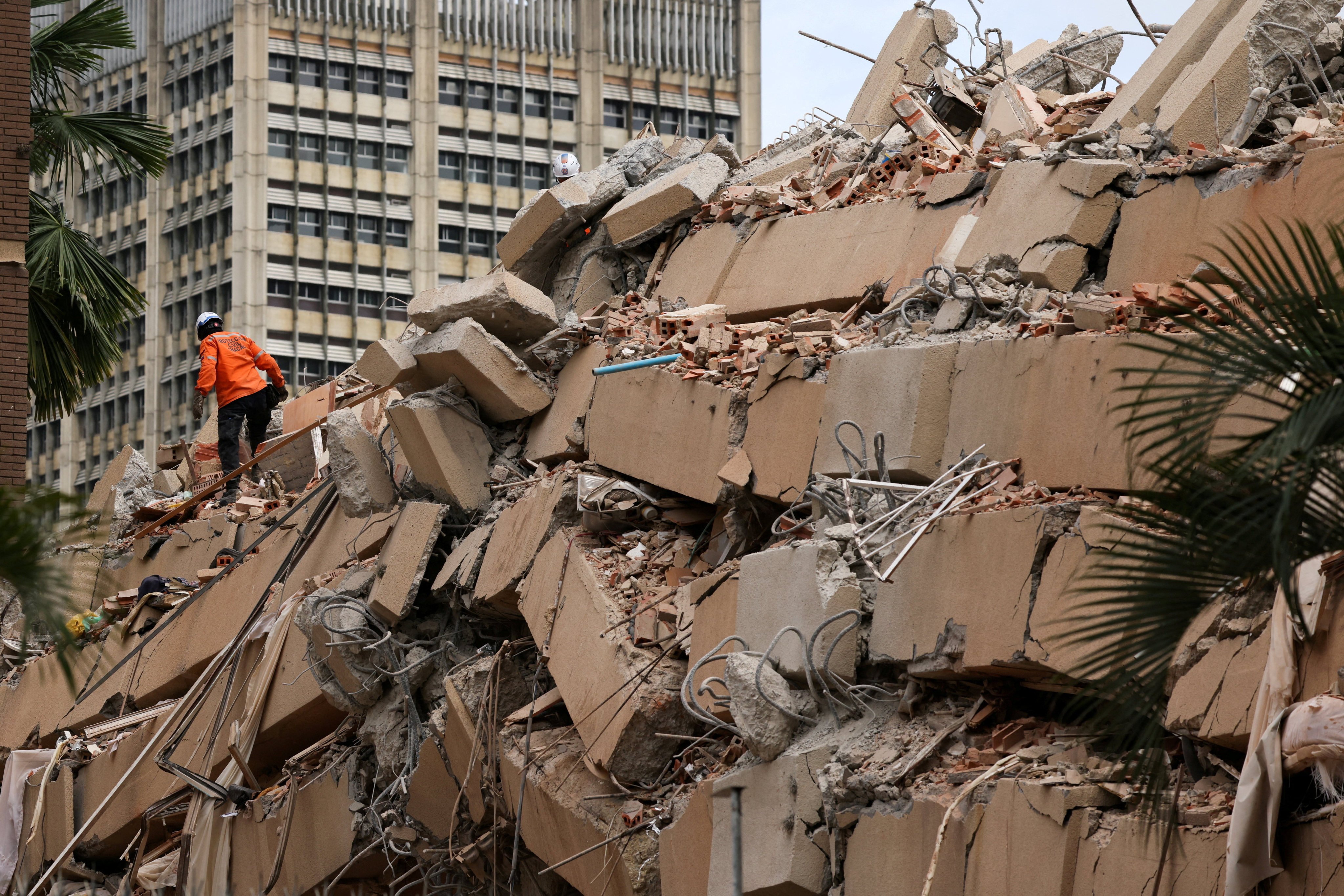 A rescuer on collapsed building in Caracas. Photo: Reuters