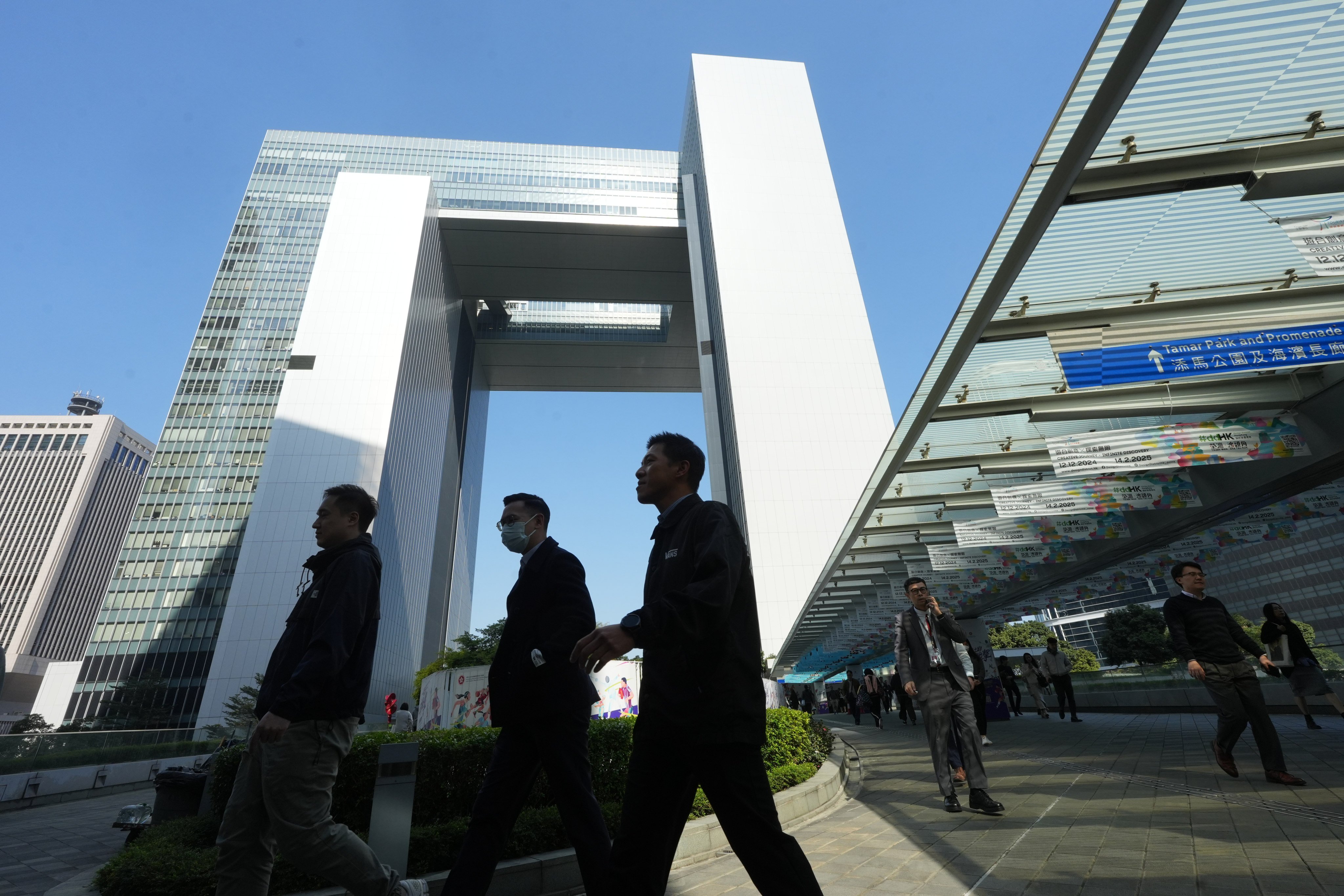 Civil servants leave government headquarters at Tamar. The administrative officer grade, which counts 755 civil servants in its ranks, is responsible for formulating policies across bureaus and departments. Photo: Sun Yeung