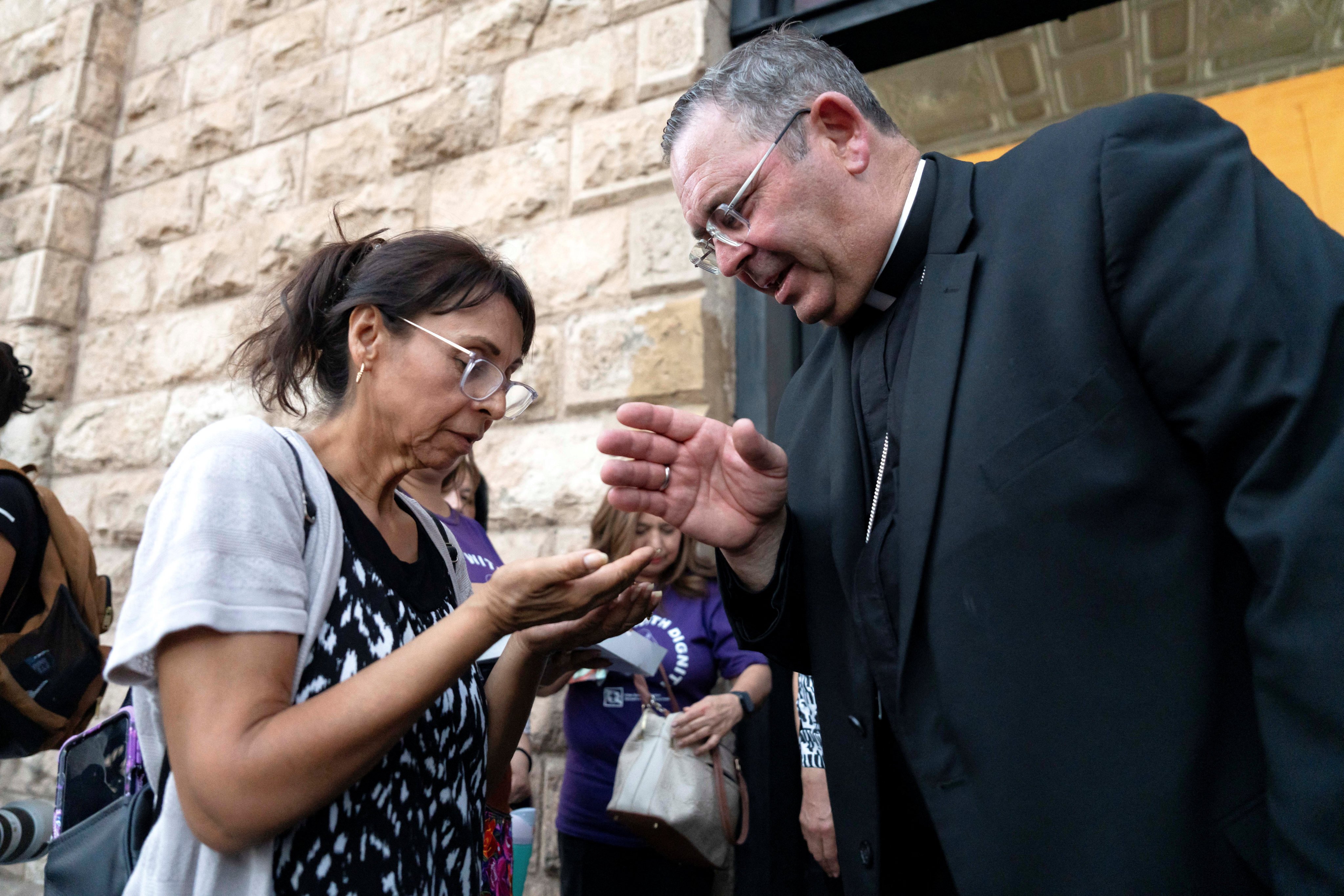 Bishop James Misko, of Tucson, Arizona, blesses a woman’s rosary during Border Mass 250 at Parroquia de la Purisima Concepción in Nogales, Sonora, Mexico, on Friday. Photo: Reuters
