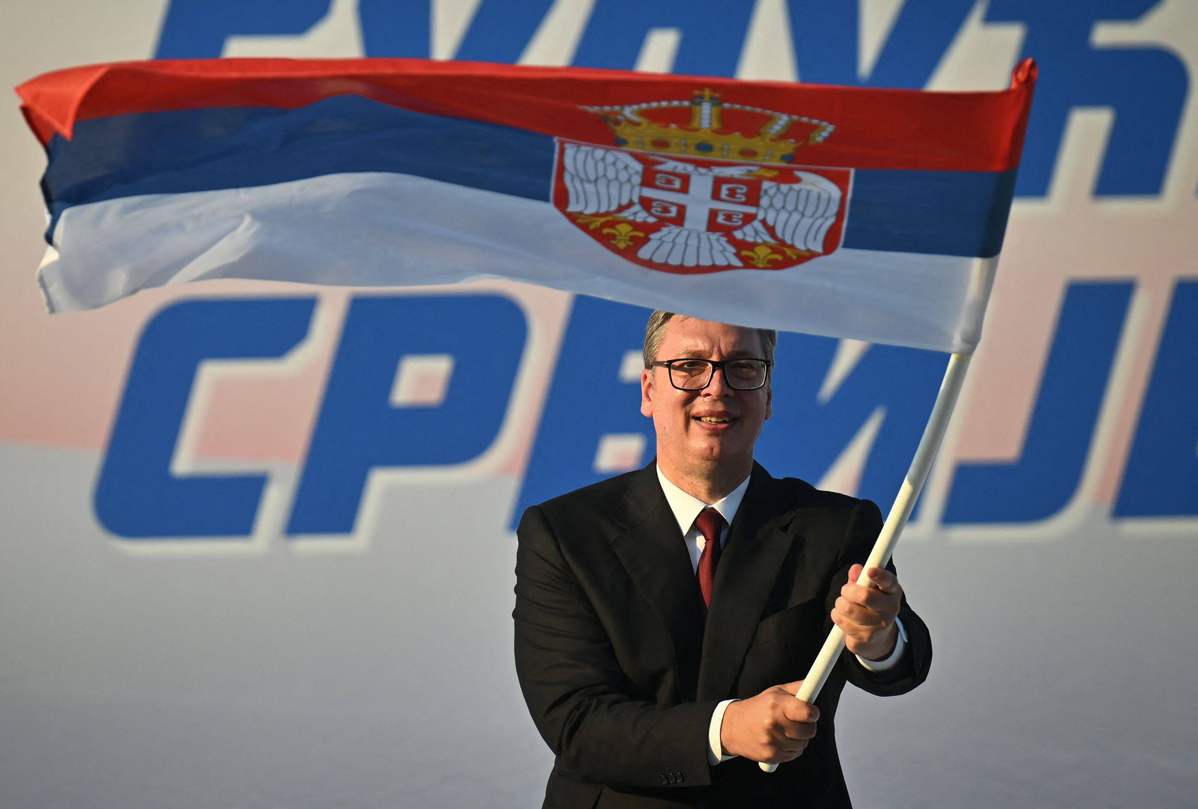 President Aleksandar Vucic waves a Serbian flag during a rally in Belgrade on Saturday. Photo: AFP