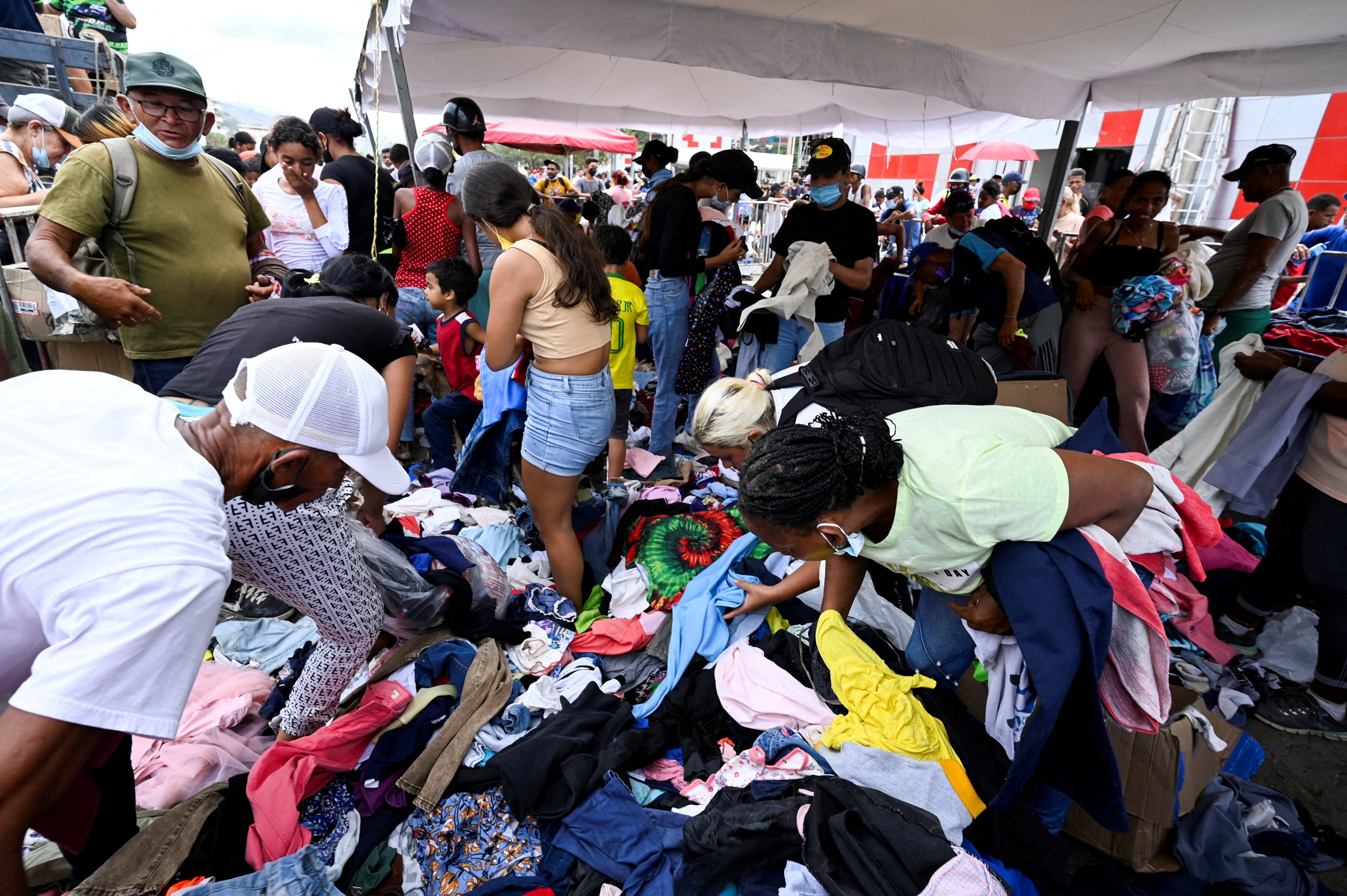 People sift through donated clothes on a street in La Guaira, Venezuela, on Sunday, following two devastating earthquakes that struck the region. Photo: Reuters