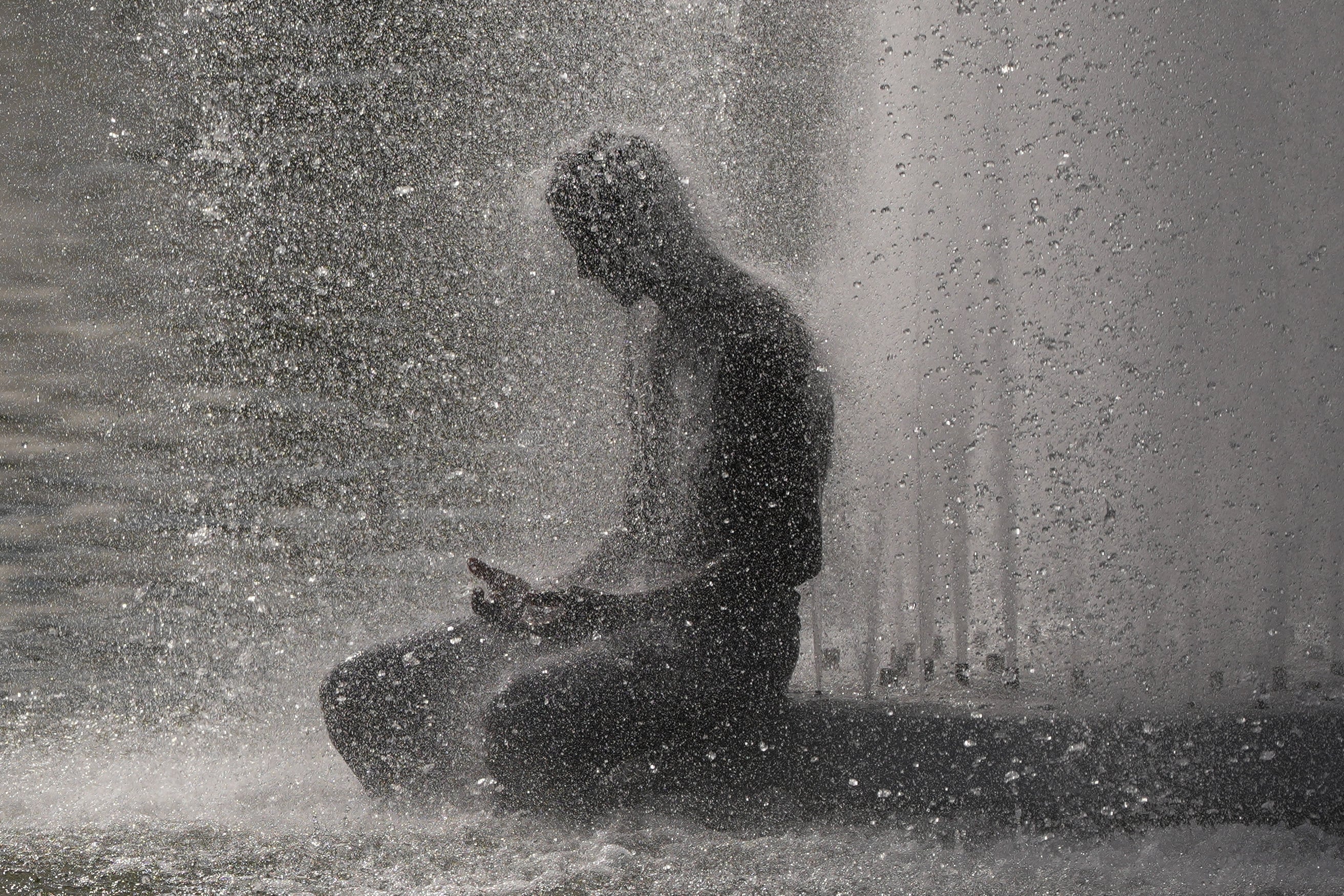 A person cools off at Trocadero fountain near the Eiffel Tower. Photo: AP