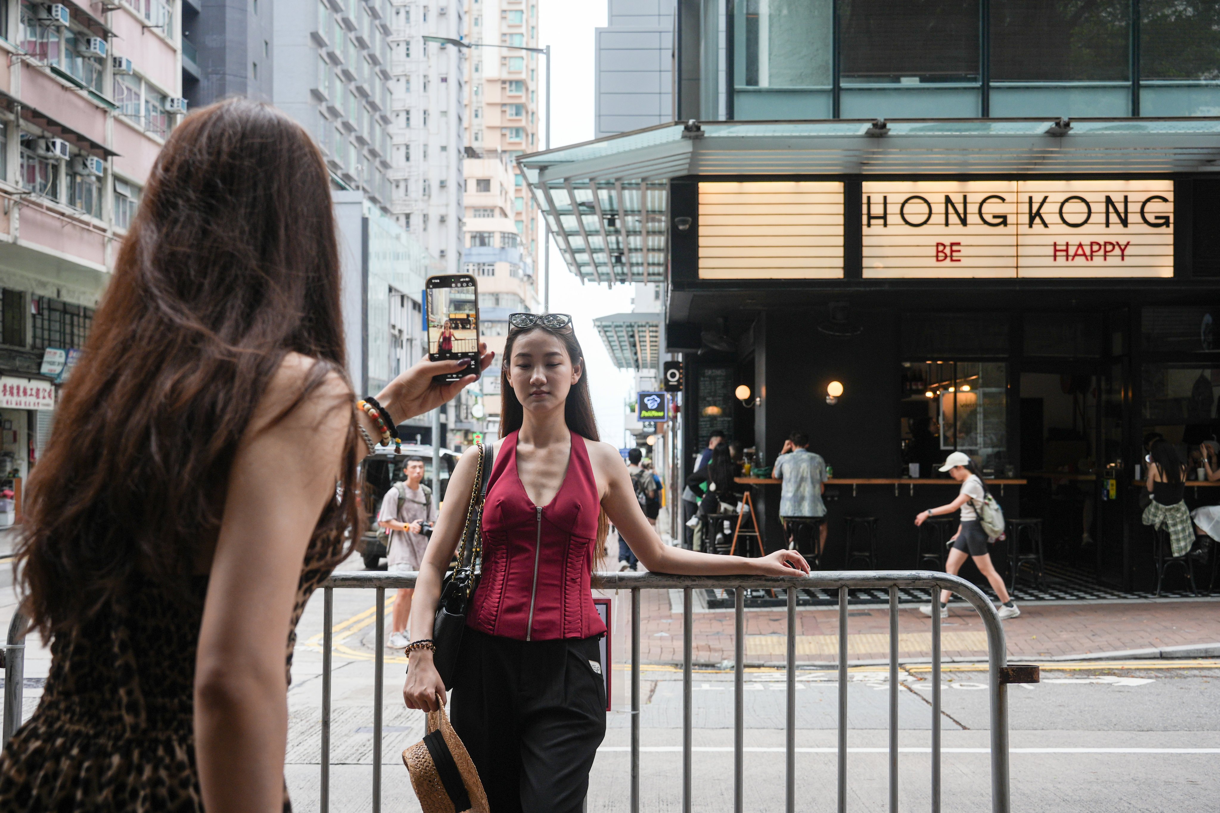 A tourist poses for a picture in Kennedy Town. Photo: Eugene Lee