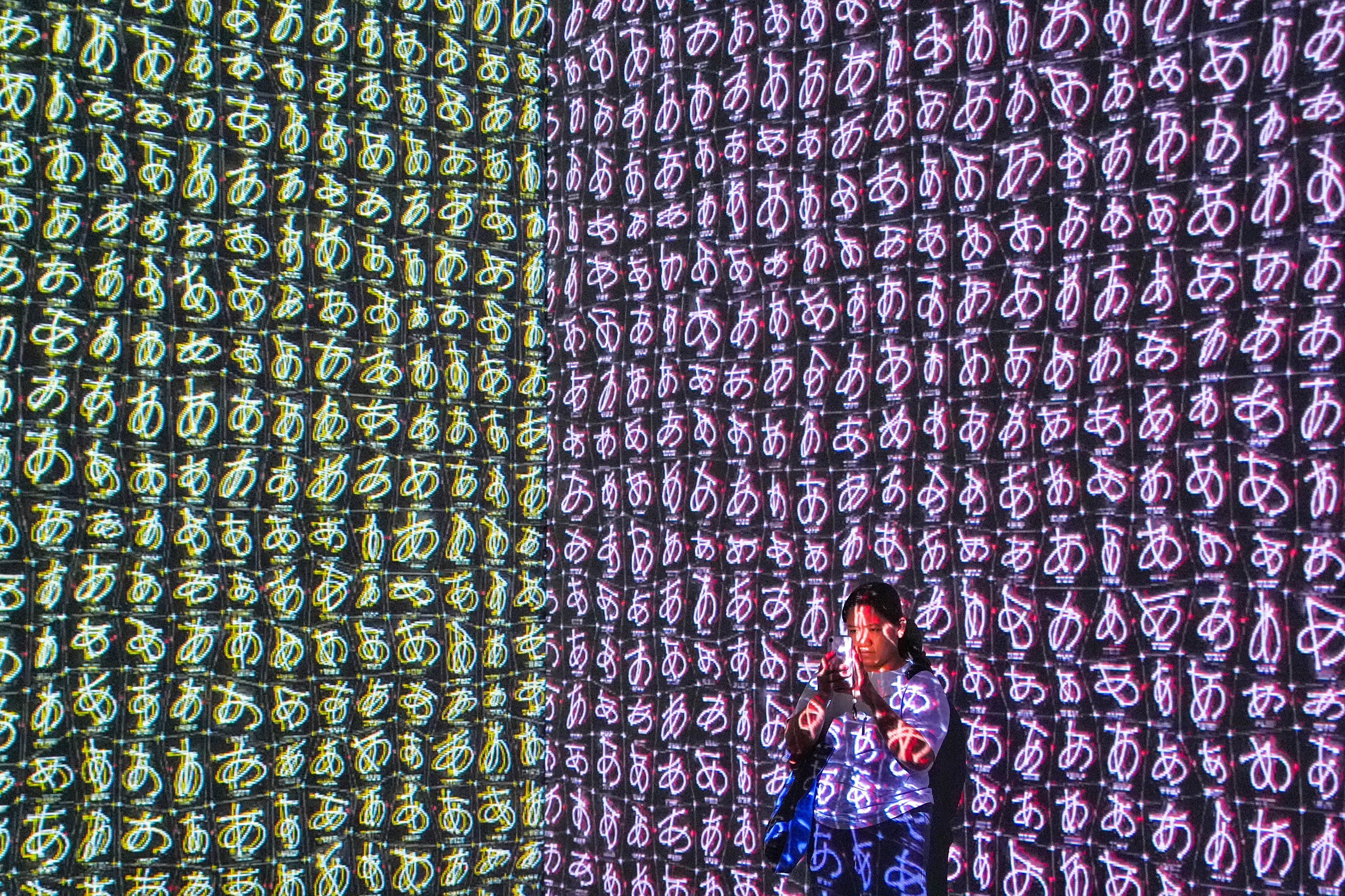 A visitor takes a photo at one of the design show’s exhibits. Photo: Elson Li
