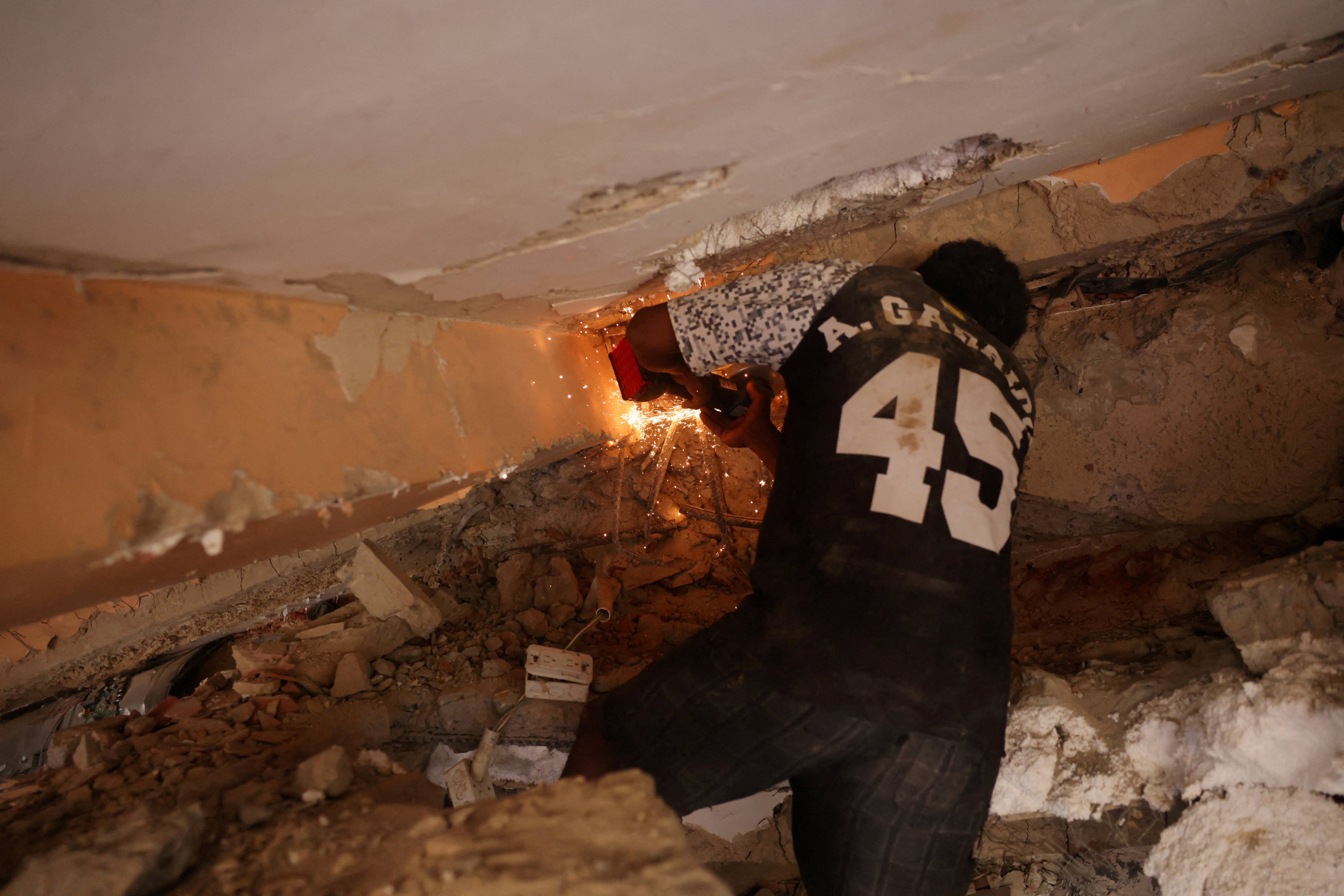 A man works on retrieving casualties from under rubble. Photo: Reuters