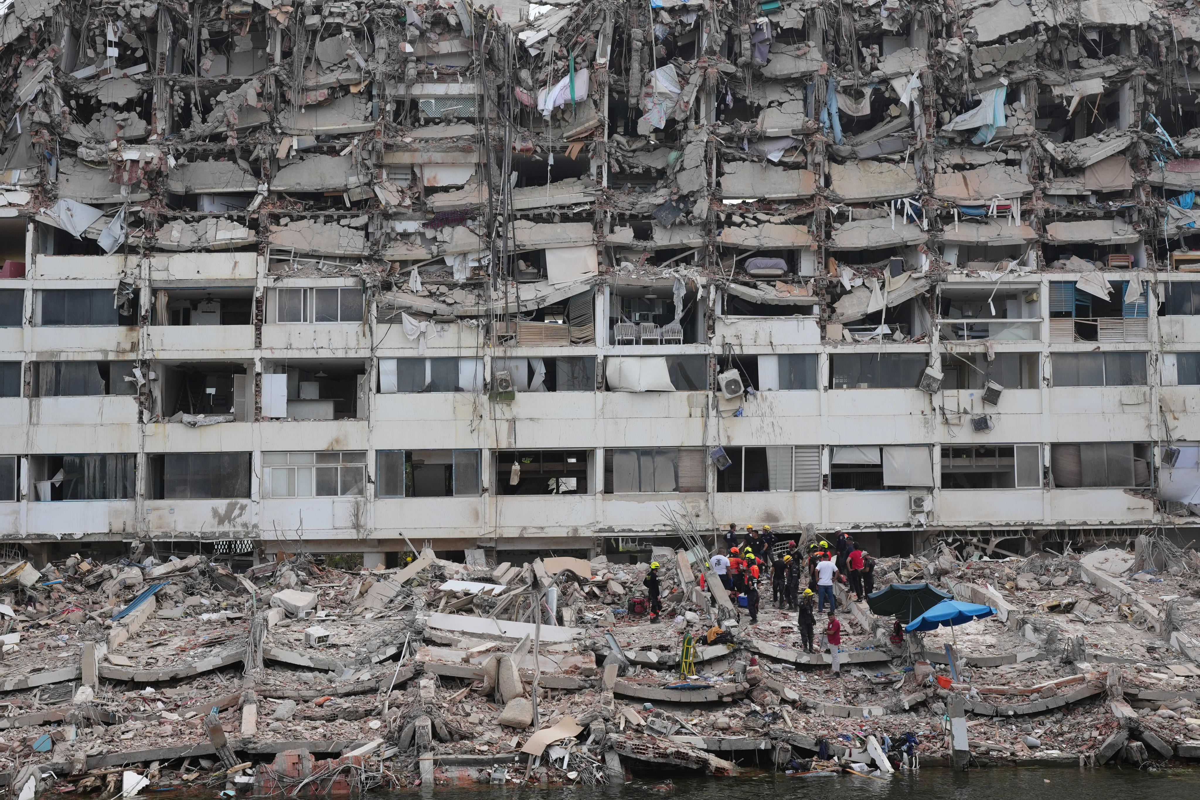 Rescuers search through the rubble in hard-hit La Guaira state. Photo: AP