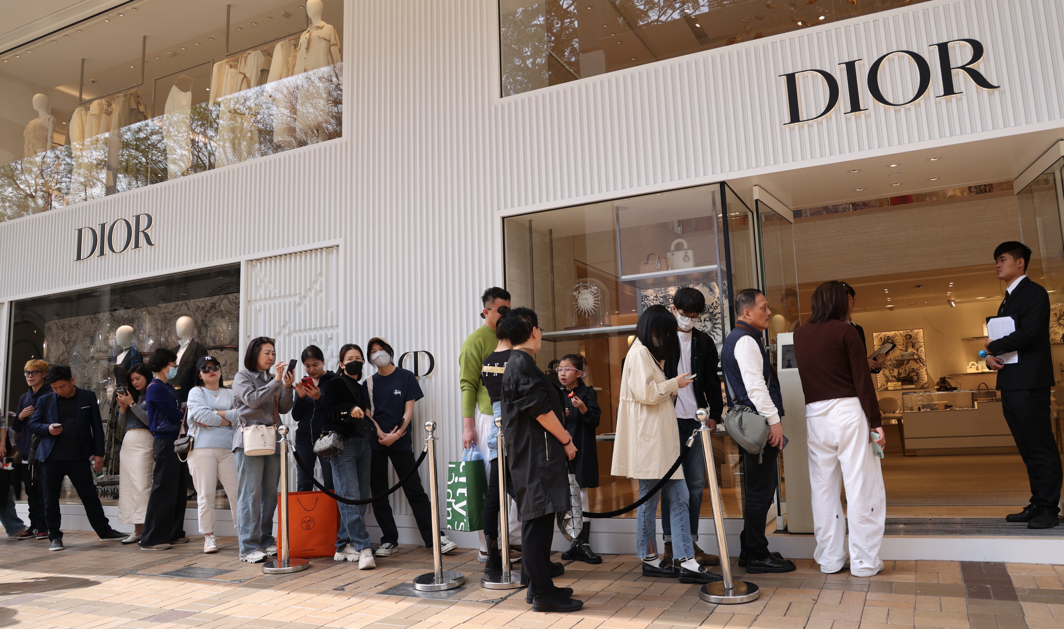 Shoppers queue outside a Dior boutique on Canton Road in Tsim Sha Tsui, Hong Kong, in 2024. The luxury market has cooled down recently, but is predicted to make a comeback by 2030. Photo: Jelly Tse