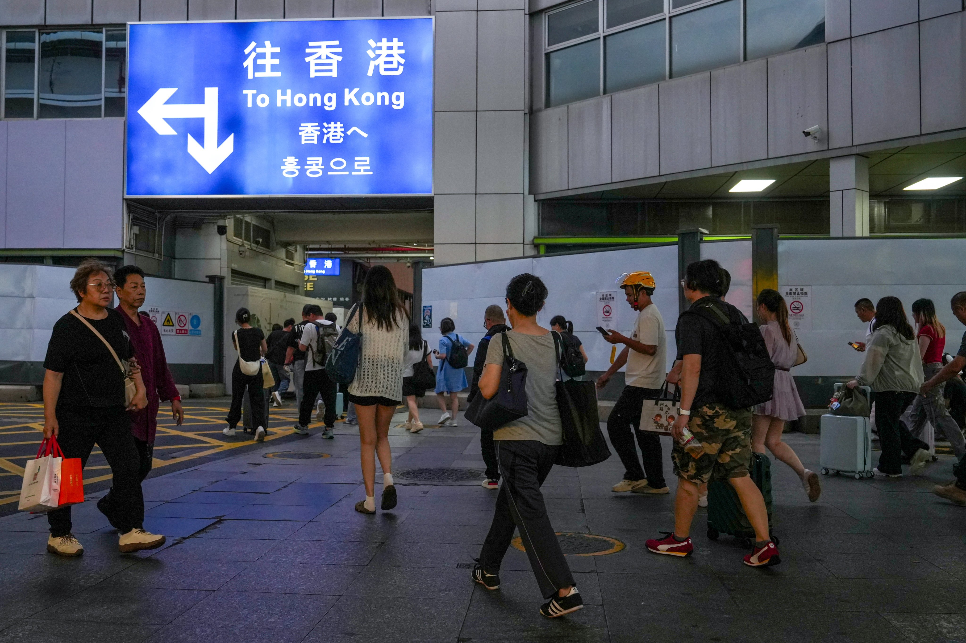 Travellers arrive at a border crossing connecting Hong Kong and Shenzhen in April. Photo: Sun Yeung