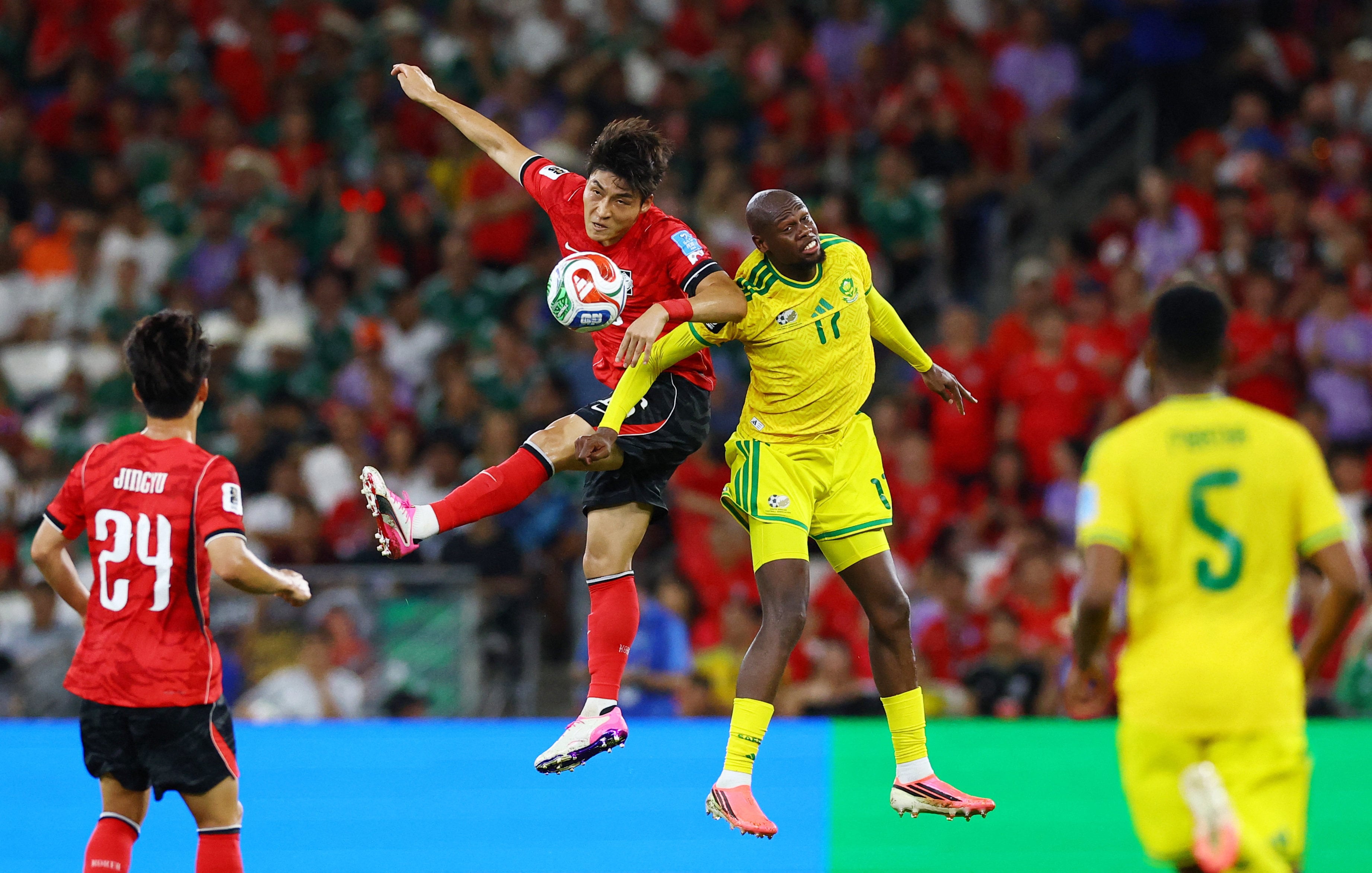 South Korea’s Park Jin-Seop (middle, in red) tussling with South Africa’s Evidence Makgopa in a match the Koreans lost 1-0 last Thursday. Photo: Reuters