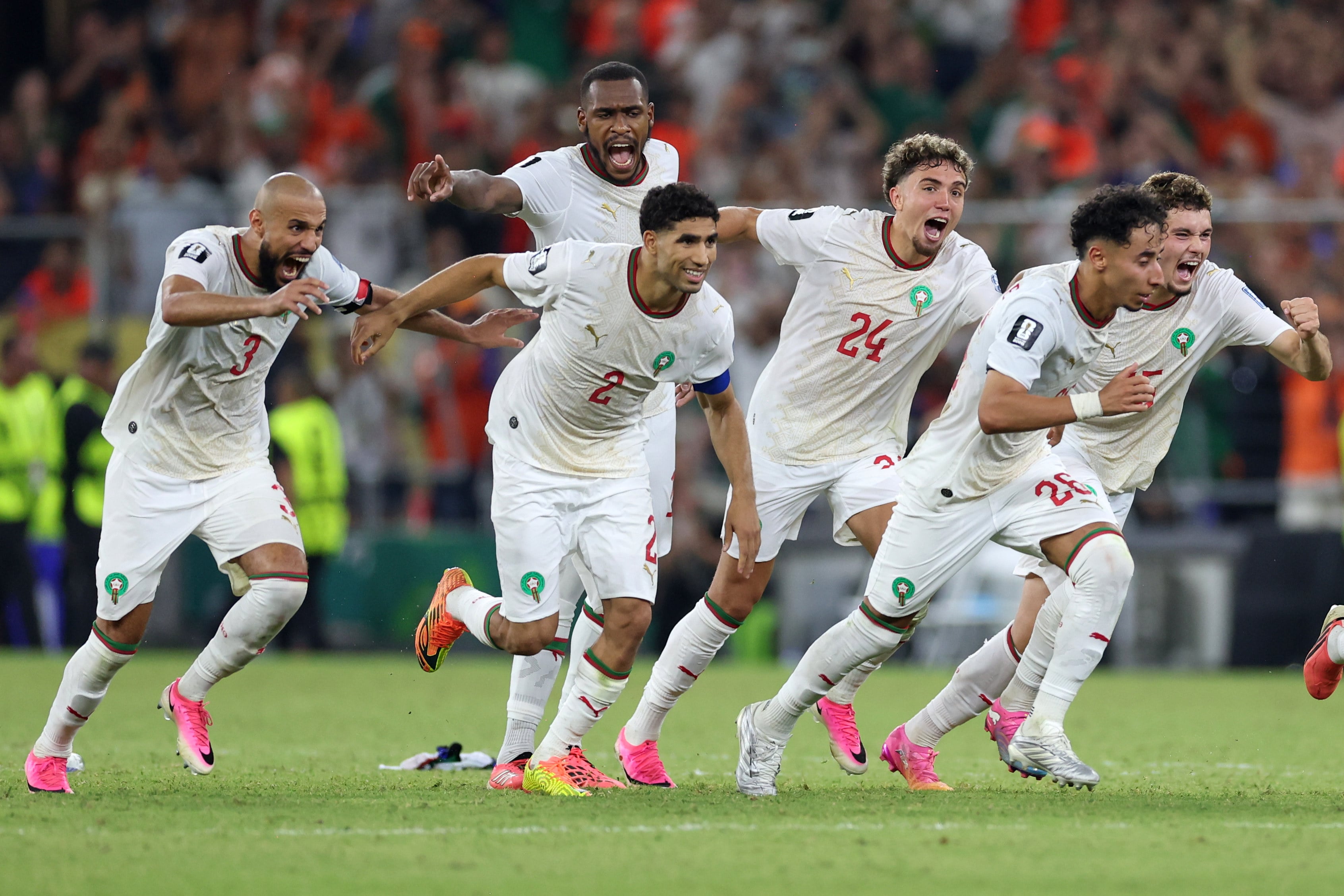 Morocco’s jubilant players begin their celebrations after Ismael Saibari’s winning penalty. Photo: AP Photo