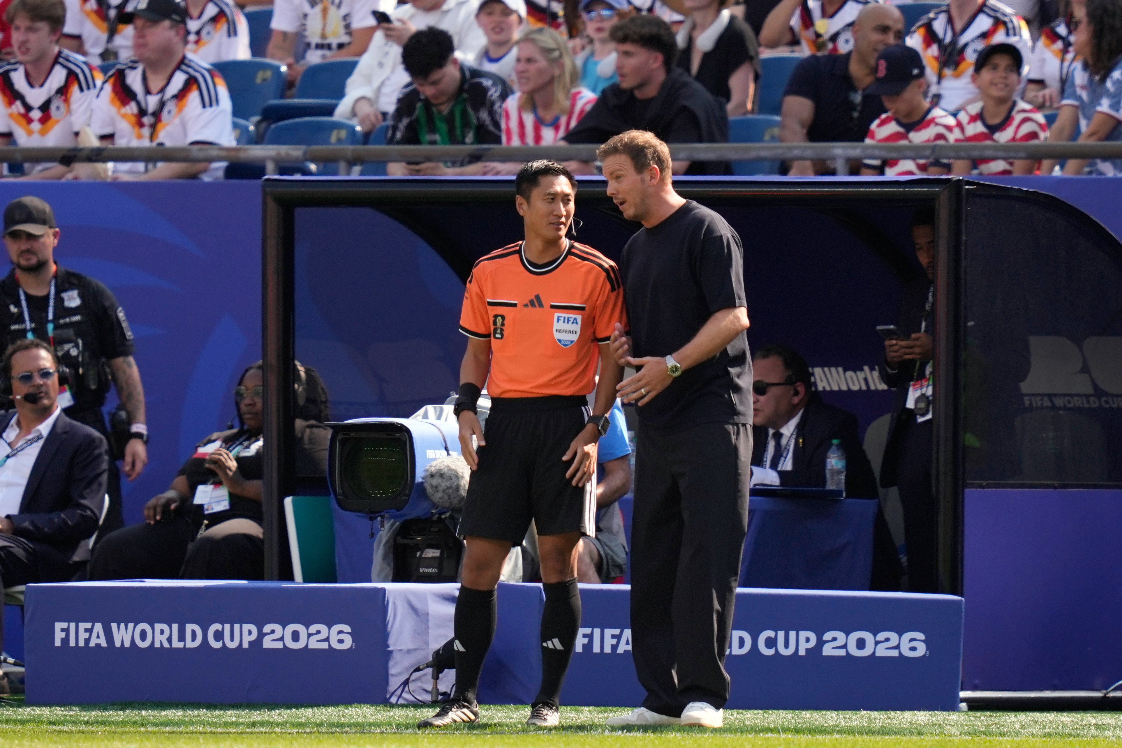 Germany head coach Julian Nagelsmann speaks to fourth official Ma Ning of China during the World Cup match against Paraguay. Photo: AP