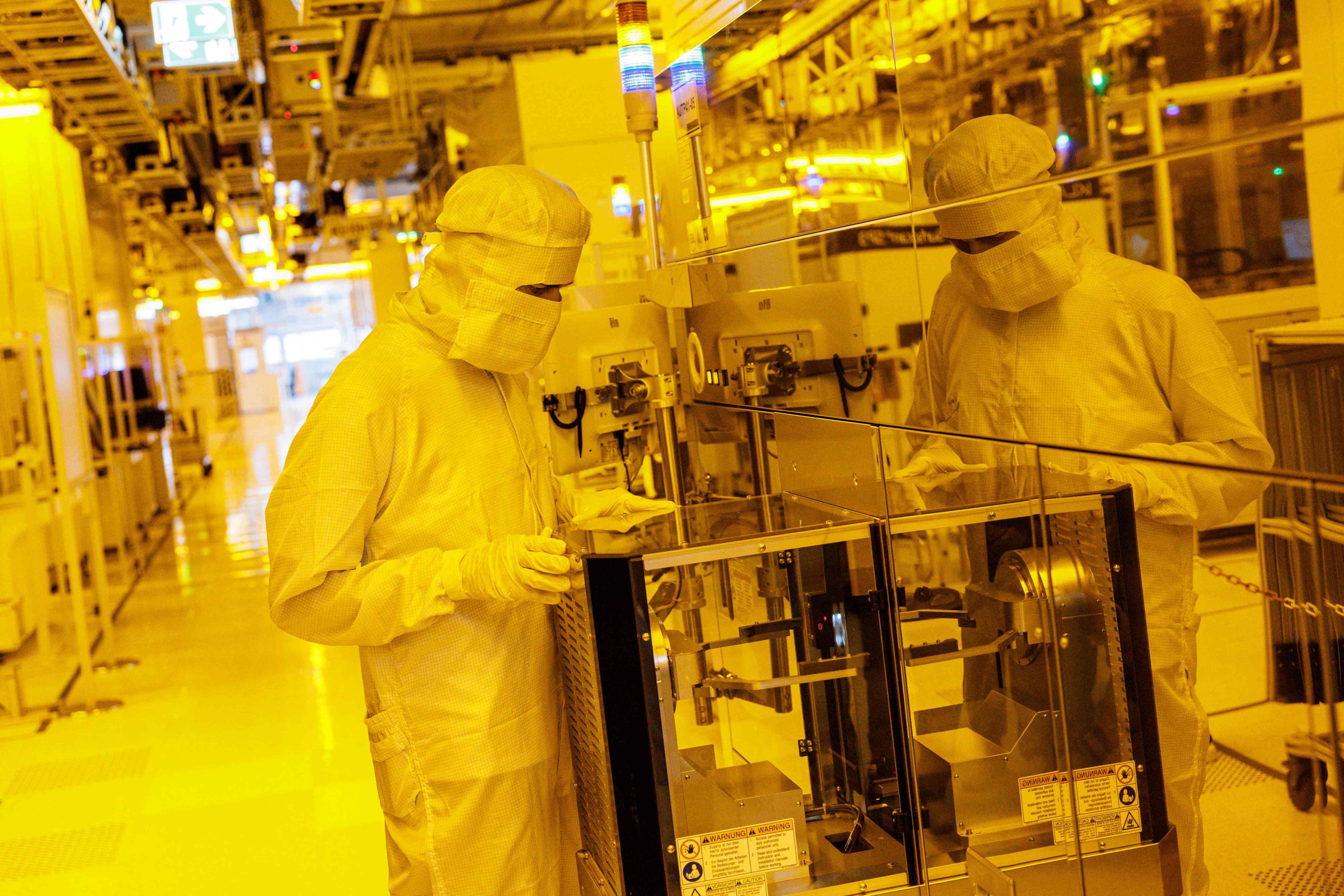Workers in the clean room of a 300mm wafer fabrication plant operated by Infineon Technologies in Dresden, eastern Germany, on June 10, 2026. Photo: AFP