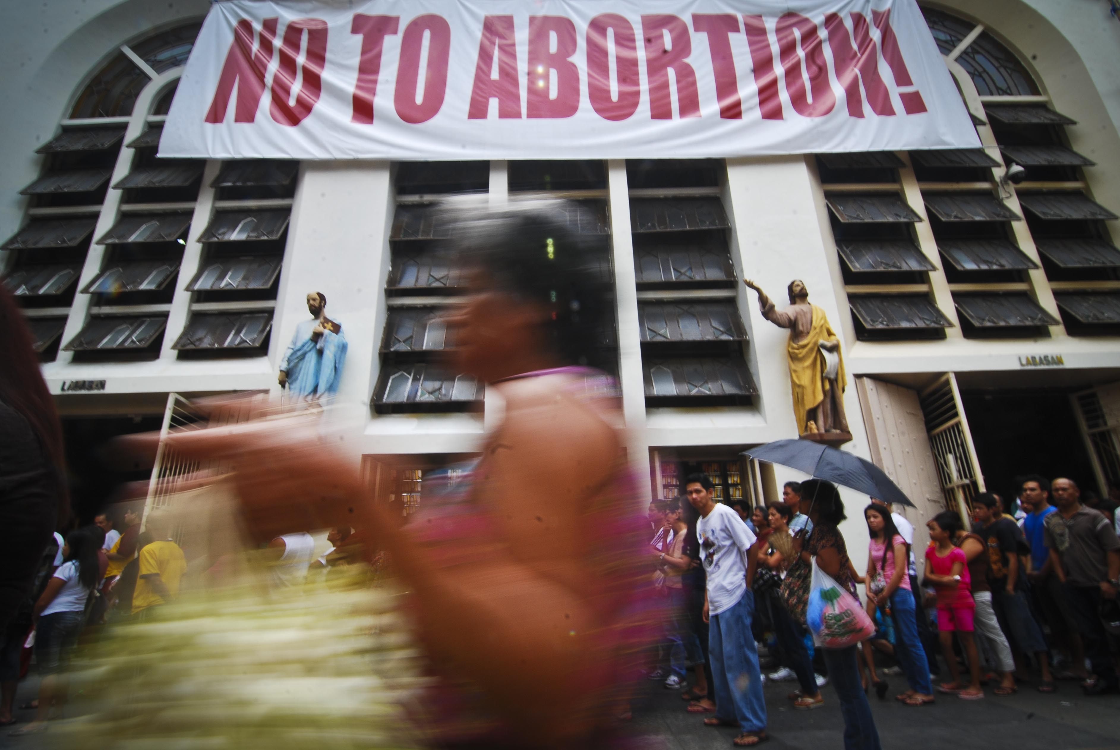A placard is displayed in front of the Minor Basilica of the Black Nazarene in Quiapo, the Philippines, during a Catholic organised anti-abortion rally in 2011. Photo: Getty Images