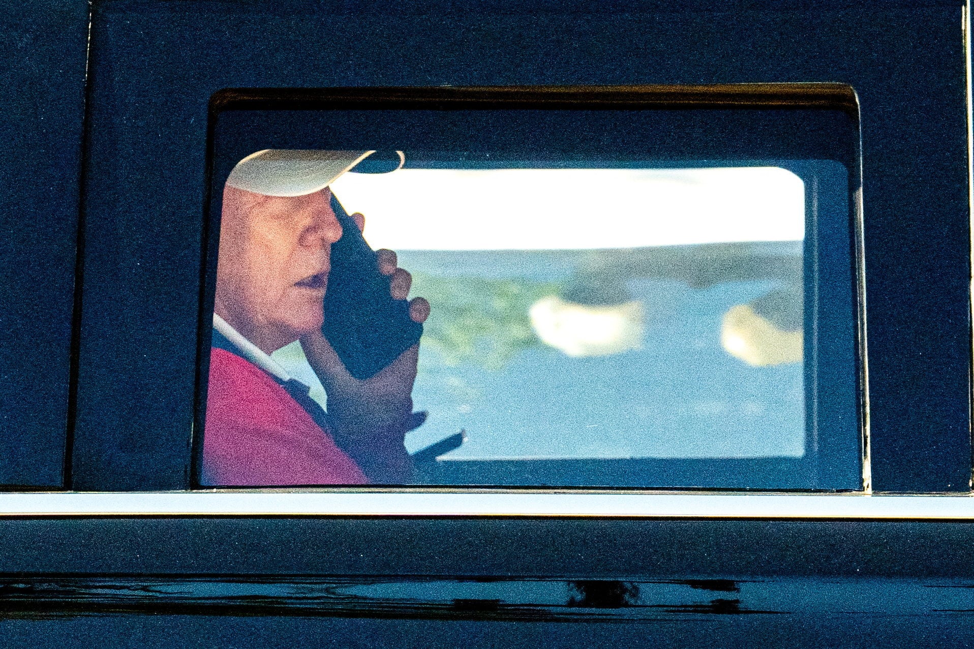 US President Donald Trump talks on the phone in his limousine known as 'The Beast'. Photo: Reuters