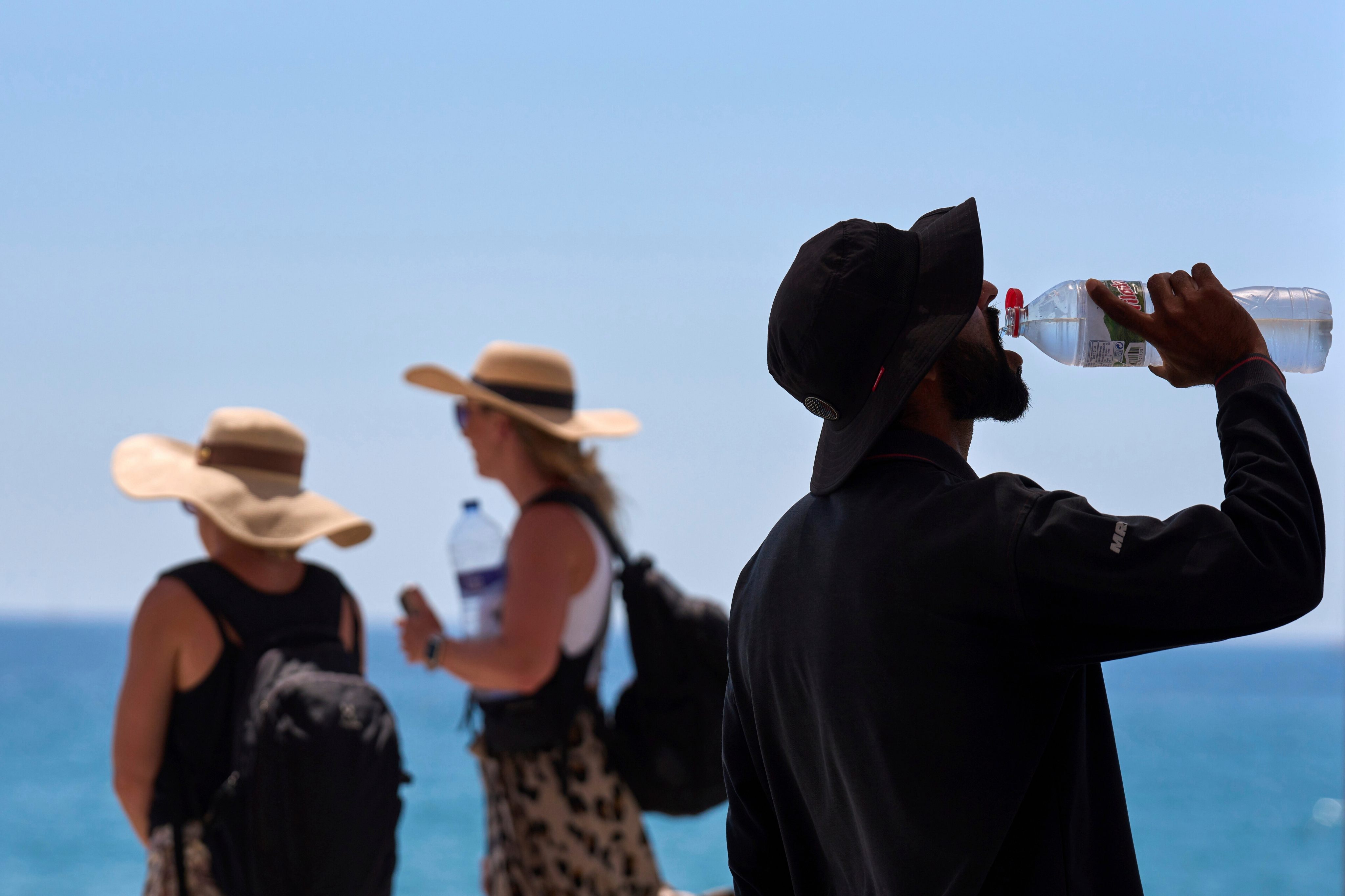 A tourist drinks water in Barcelona, Spain, on a hot day. File photo: AP