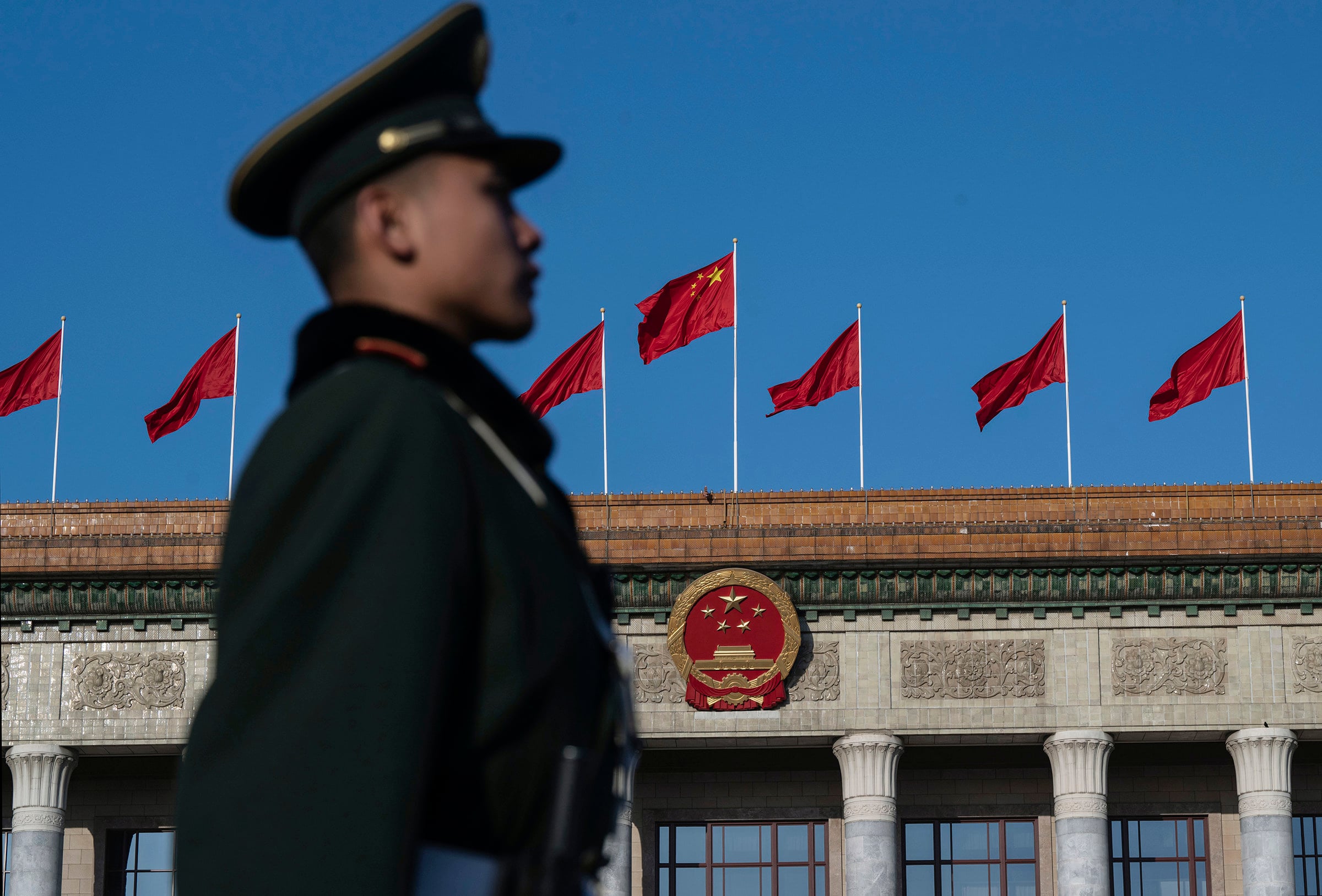 A guard stands at attention outside the Great Hall of the People in Beijing. China has enacted a sweeping overseas investment law. Photo: TNS