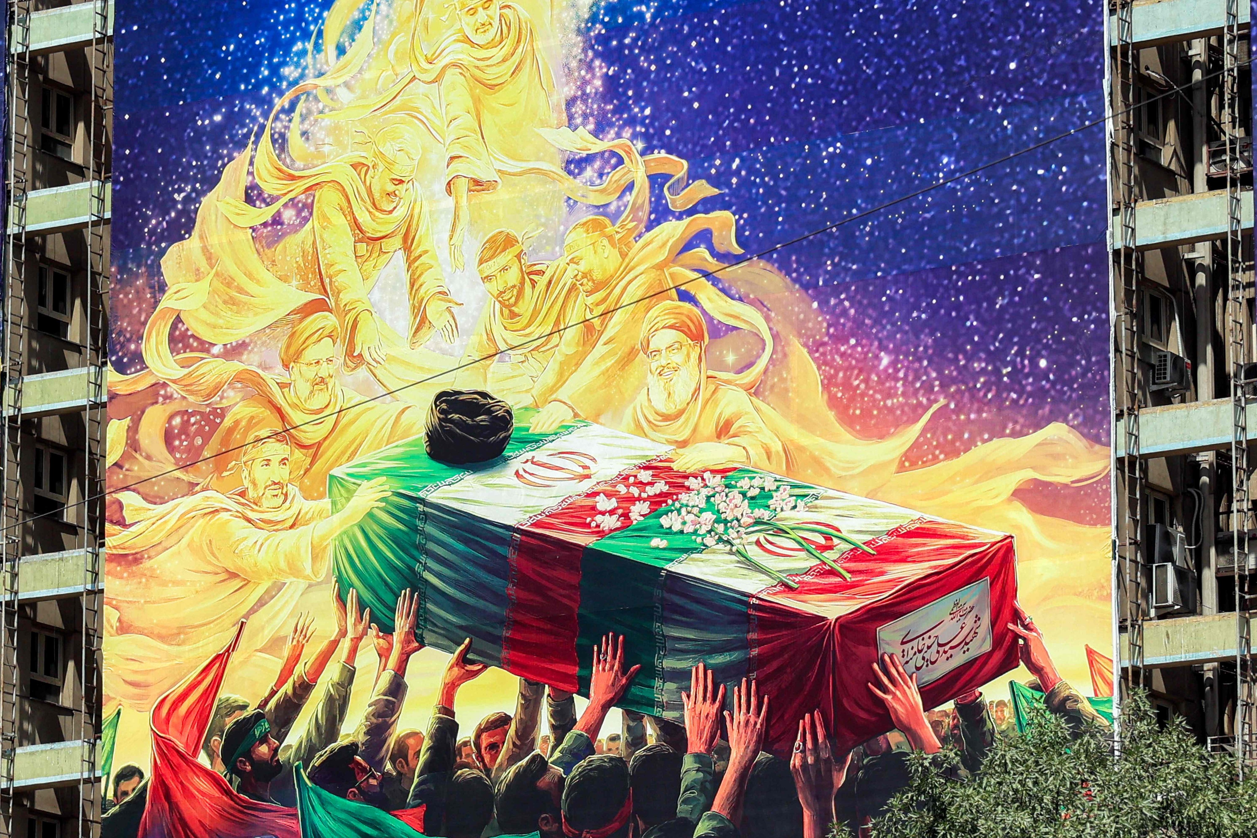 A mural in Tehran depicts late figures aligned with the Iranian government, all carrying the flag-draped casket of Iran’s slain supreme leader Ali Khamenei. Photo: AFP