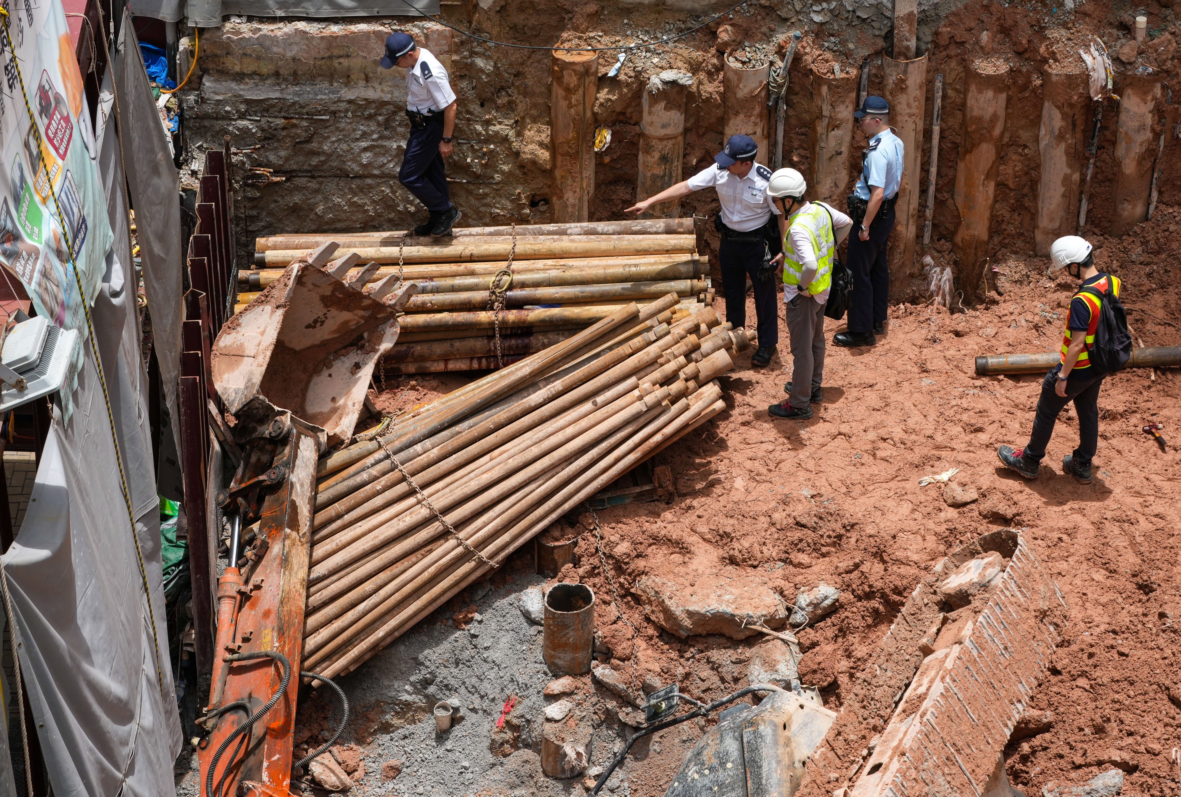 Police inspect the scene of the fatal excavator accident on Monday. Photo: Jelly Tse