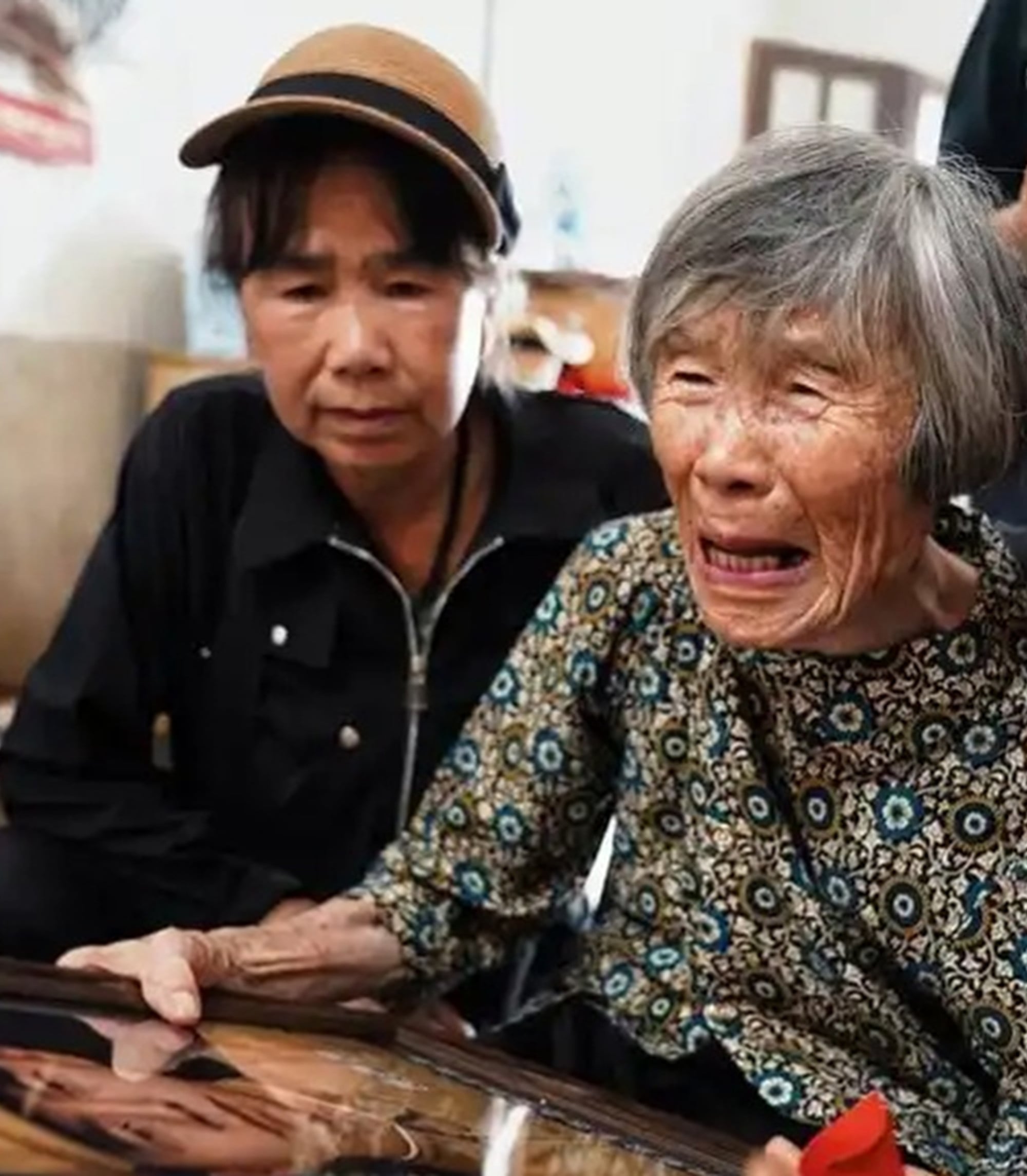 Holding Zhang’s portrait, Zhao, above, gazed upon the face of her husband as a young man, and she was immediately overwhelmed with emotion. Photo: Handout Holding Zhang’s portrait, Zhao, above, gazed upon the face of her husband as a young man, and she was immediately overwhelmed with emotion. Photo: Handout