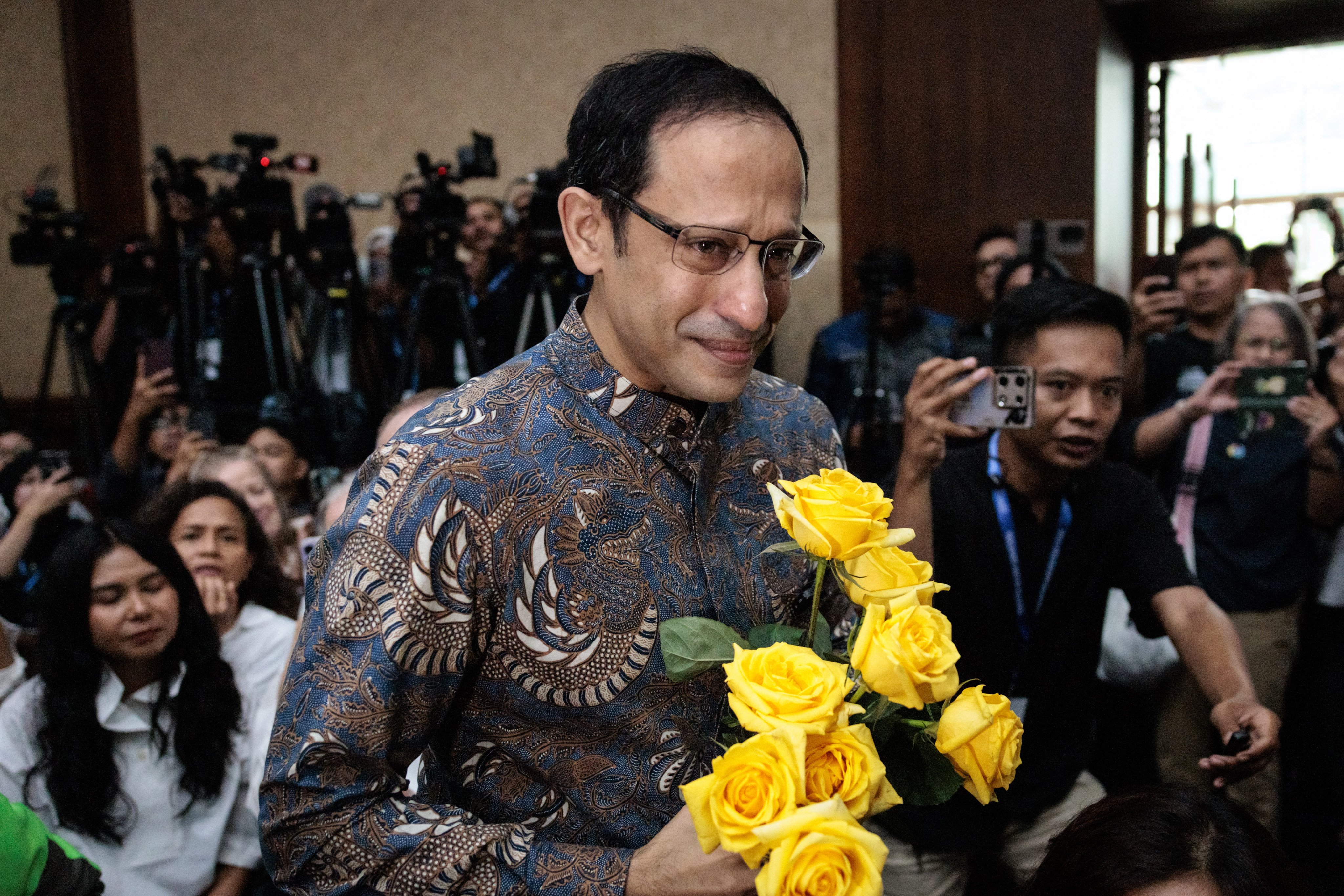 Nadiem Makarim (R), Indonesia’s former education minister and co-founder of ride hailing company Gojek, arrives for a verdict hearing at the Central Jakarta District Court in Jakarta on June 30, 2026, in a corruption case related to the procurement of Chromebook laptops for schools during the Covid-19 pandemic. Judges found him guilty of corruption, sentencing him to 10 years in prison. The court also ordered Nadiem to pay a fine of 1 billion rupiah ($55,850) and 809 billion rupiah (more than $45 million) in restitution, or serve an additional prison term. (Photo by YASUYOSHI CHIBA / AFP)