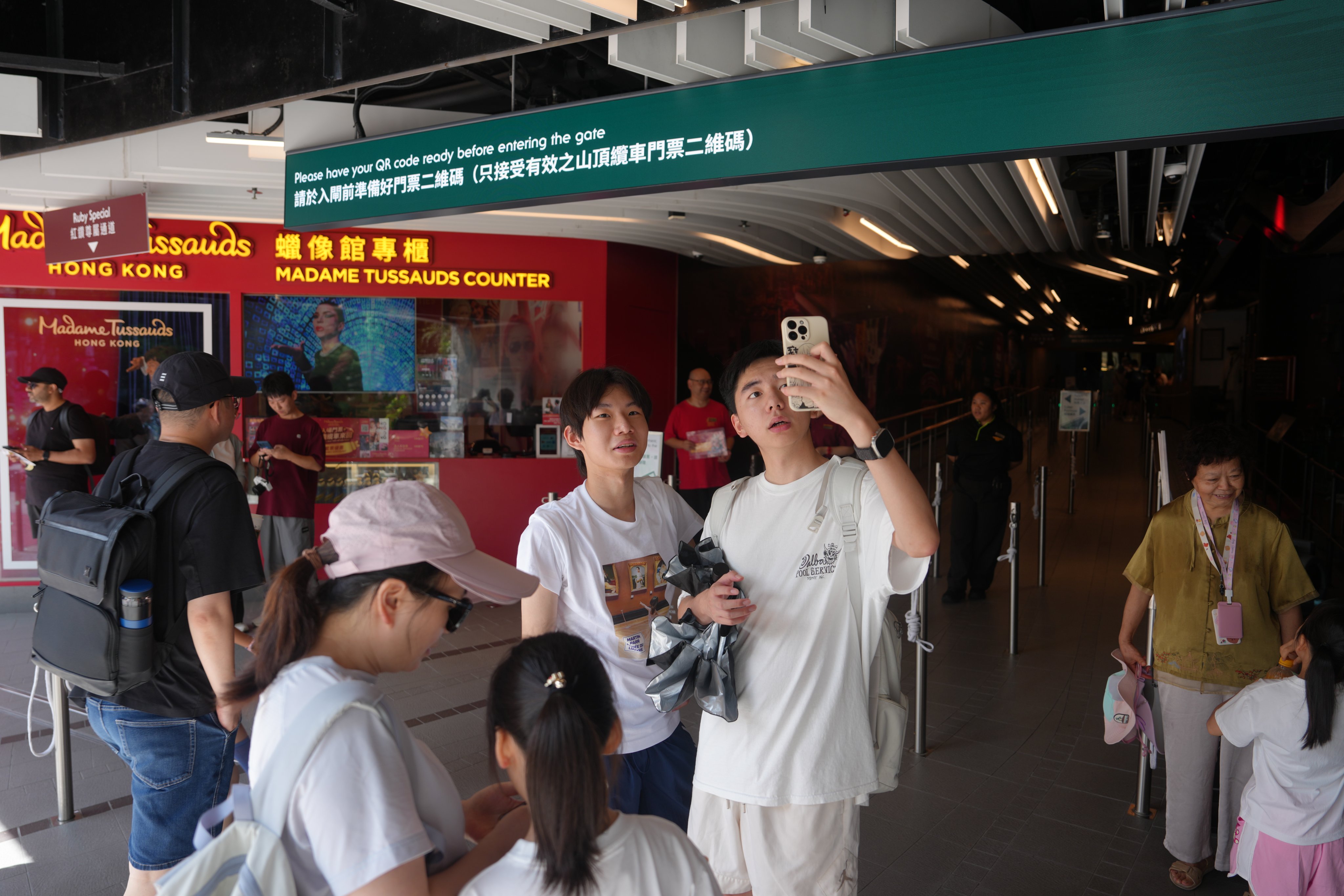 At The Peak Tram terminus in Central, visitors queue up for a 15 per cent discount on return tickets. Photo: Sam Tsang