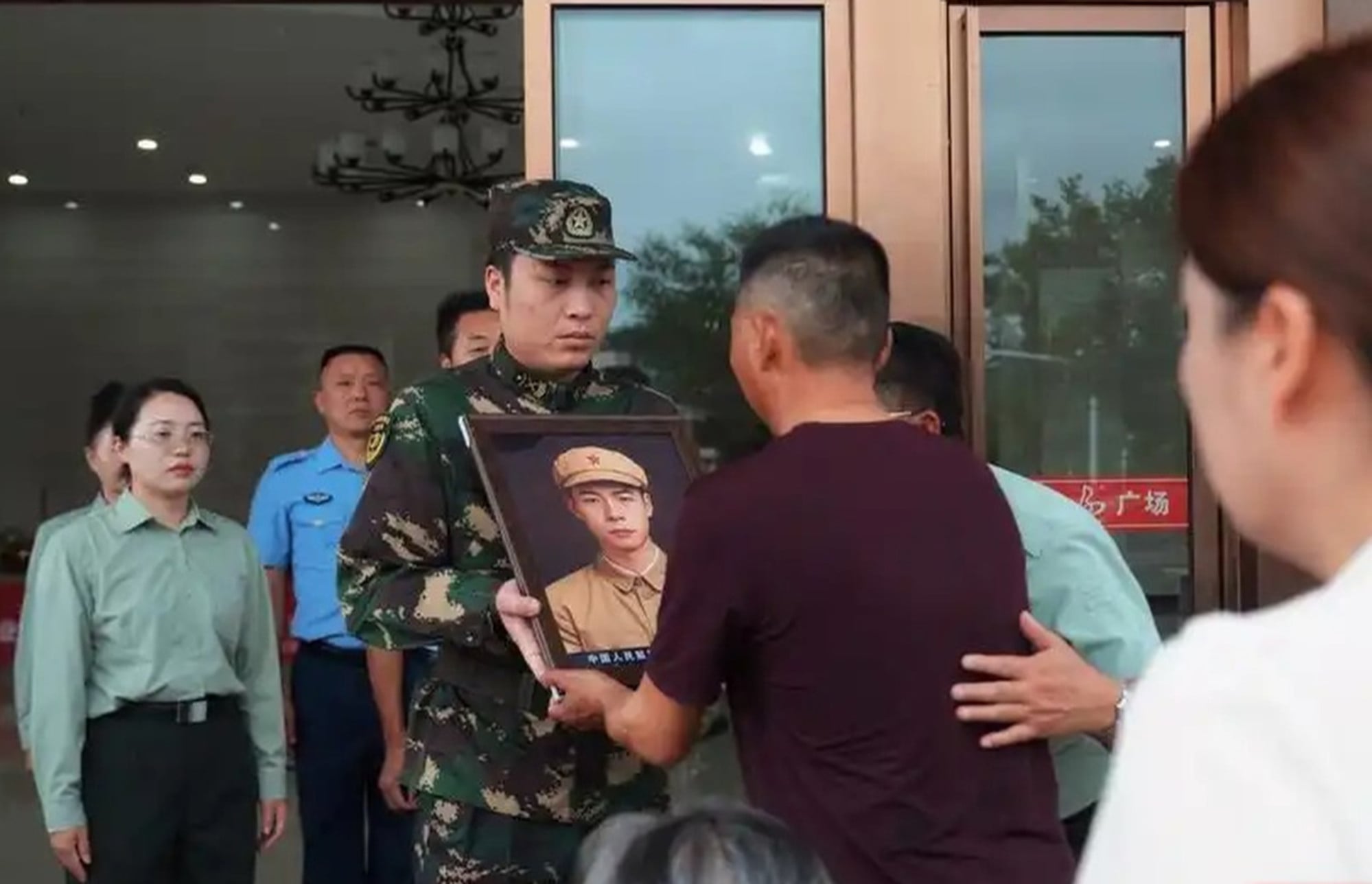 In May, a Nanjing University volunteer team, supported by Hunan authorities, began restoring faces of fallen Dongshan Island Battle soldiers. The picture shows a portrait being returned to a family. Photo: Handout In May, a Nanjing University volunteer team, supported by Hunan authorities, began restoring faces of fallen Dongshan Island Battle soldiers. The picture shows a portrait being returned to a family. Photo: Handout