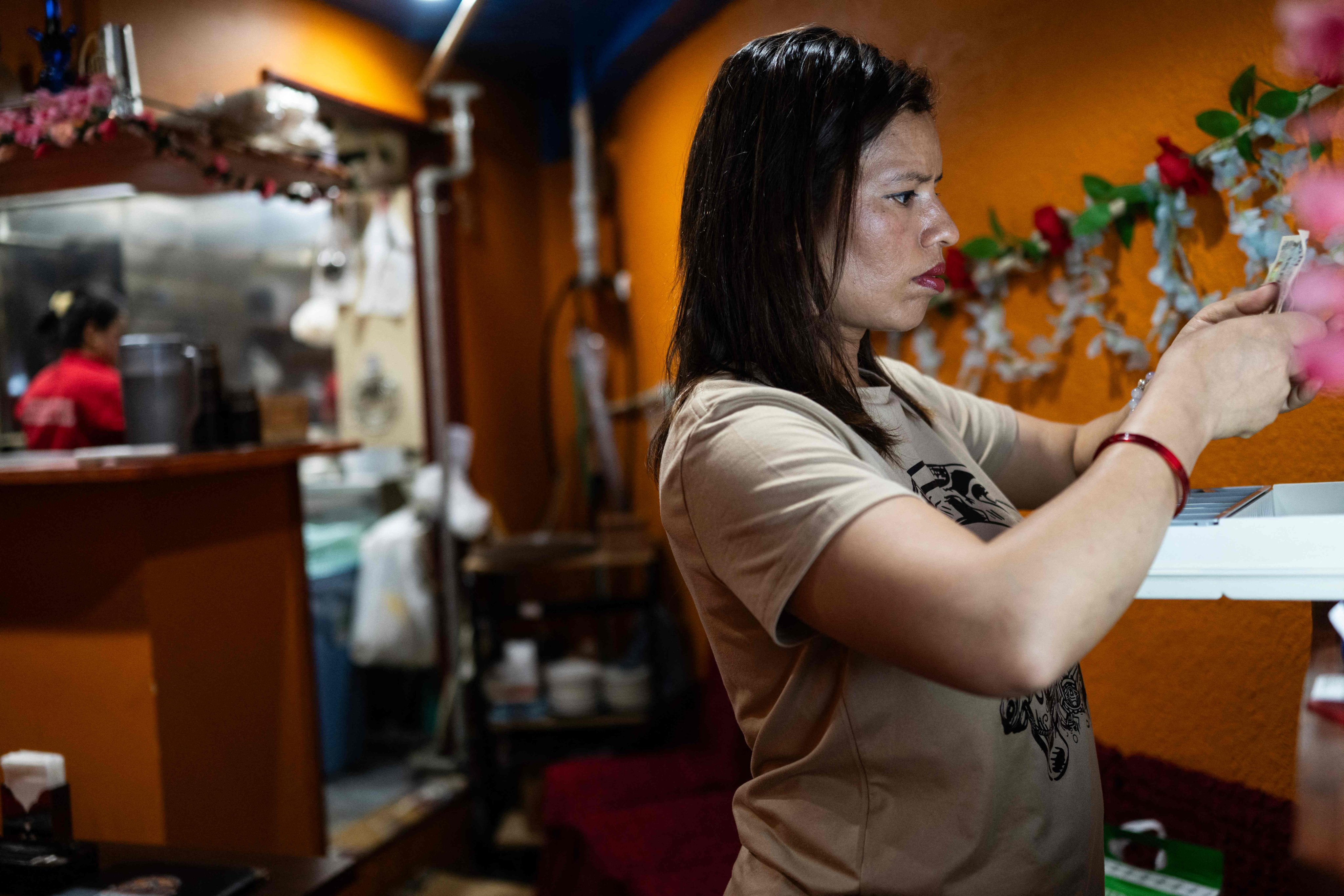 Budhathoki Samjhana checks receipts at Chitwan Rhino Restaurant and Bar in Tokyo’s Okubo-Shin area on June 12. Photo: AFP
