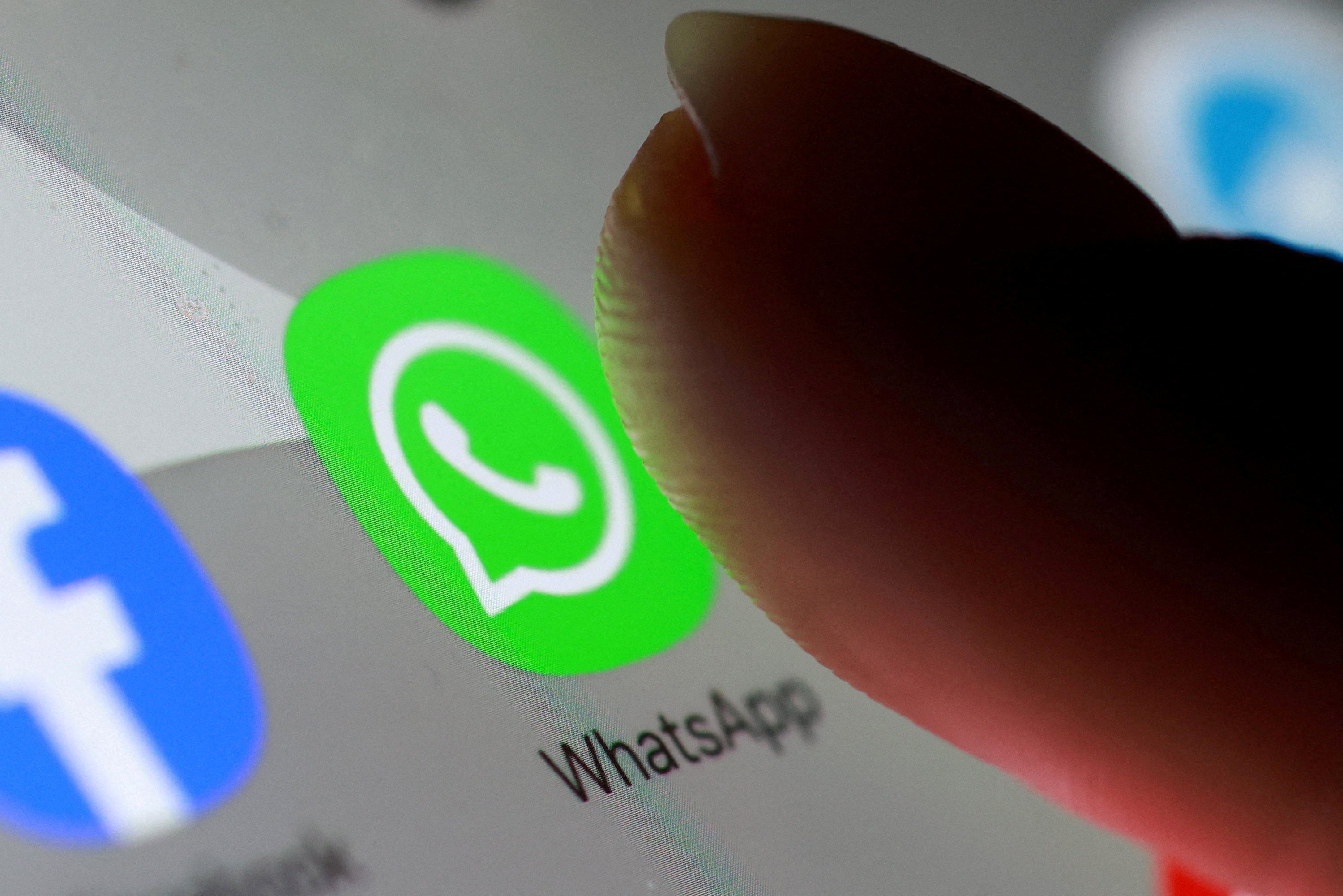 The WhatsApp app icon is seen on a smartphone. India has asked WhatsApp to justify the implementation of ​a planned feature covering usernames and to freeze the rollout. Photo: Reuters