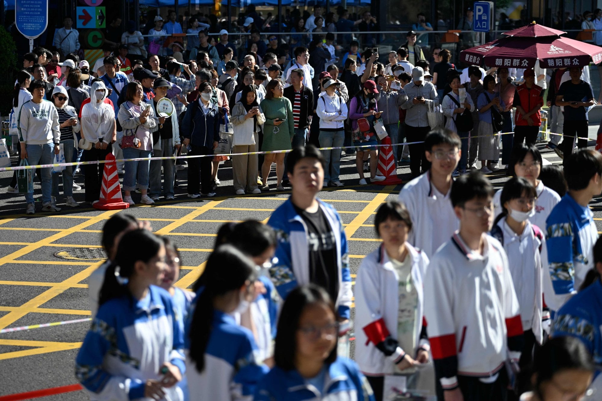 Parents, at the back, look on as students line up to enter a test centre in Beijing on June 7, 2026, marking the first day of China’s gaokao. Wang Zhao/AFP Parents, at the back, look on as students line up to enter a test centre in Beijing on June 7, 2026, marking the first day of China’s gaokao. Wang Zhao/AFP