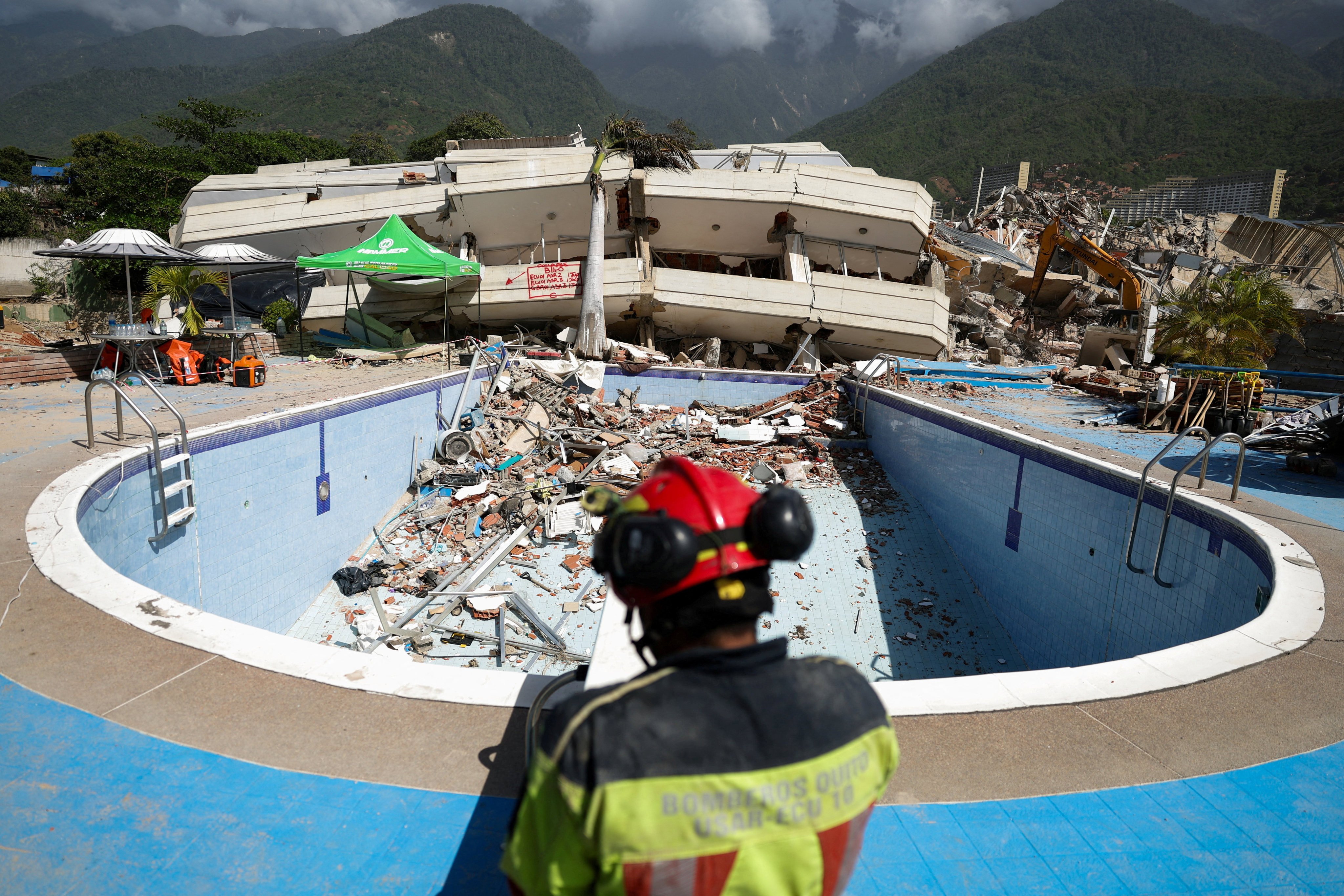 A firefighter at the site of a collapsed building. Photo: Reuters