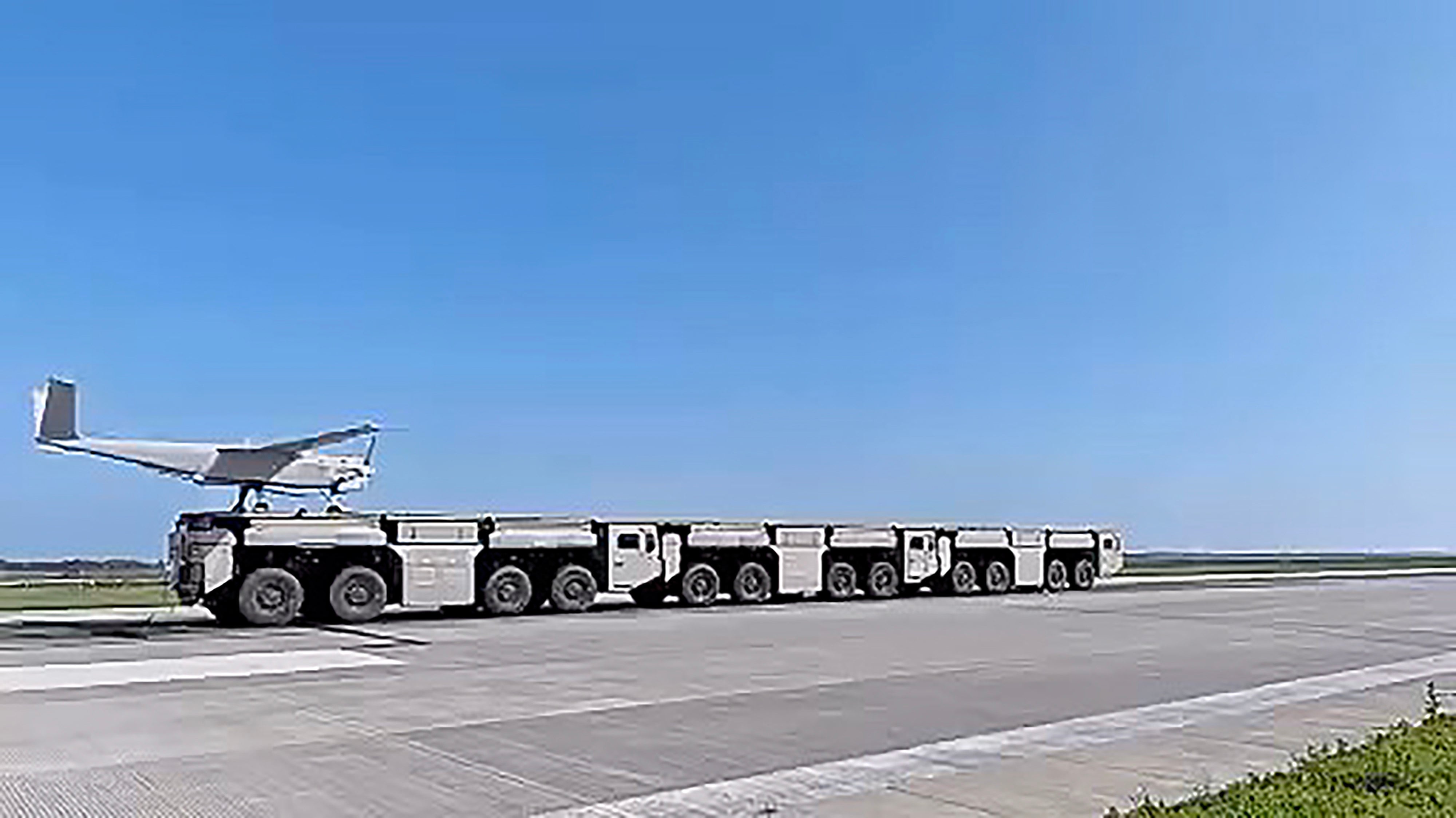 A drone is launched from an electromagnetic catapult system using interconnected trucks that form a continuous platform. Photo: BIT/WeChat