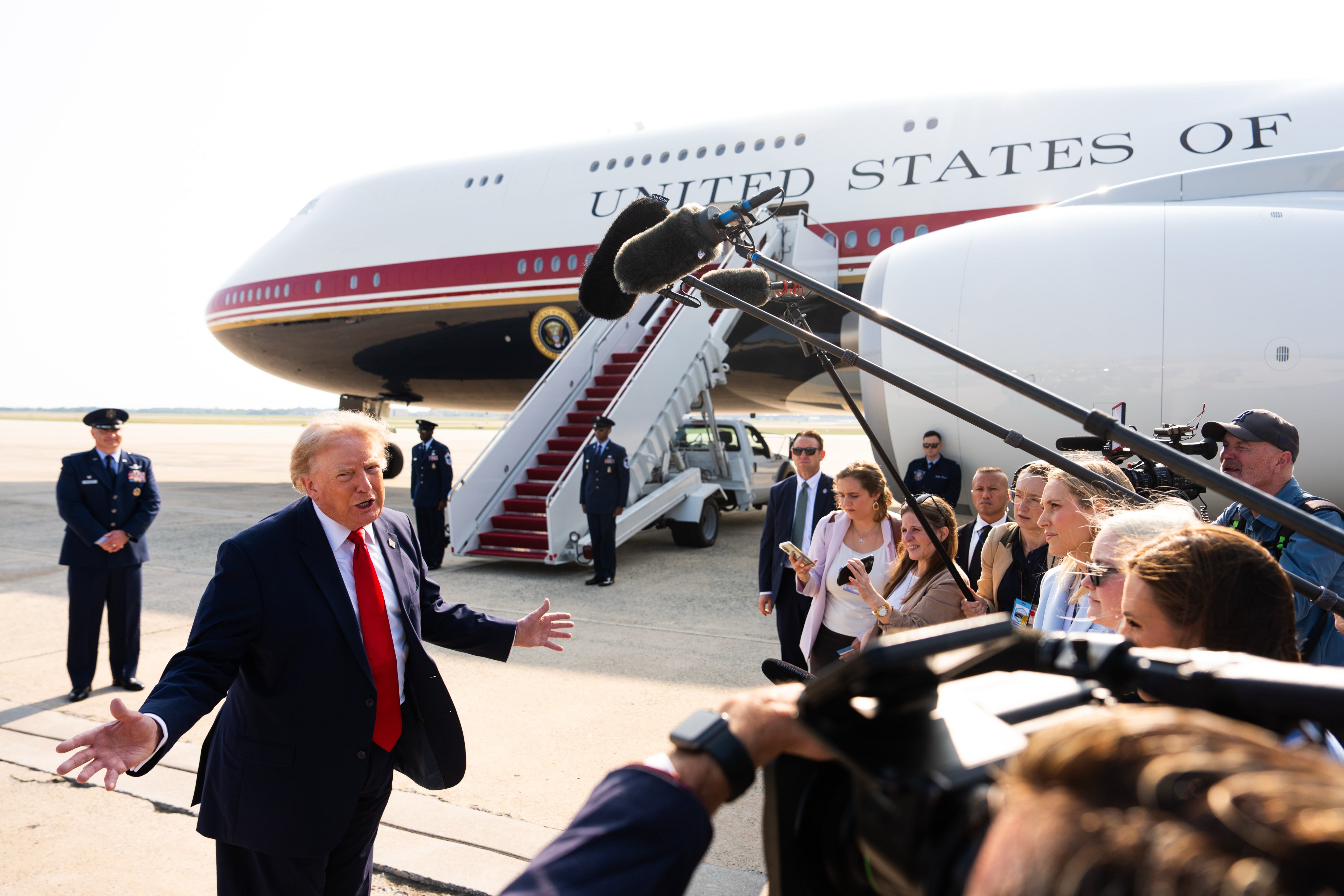 President Donald Trump speaks with reporters before boarding the new Air Force One. Photo: AP