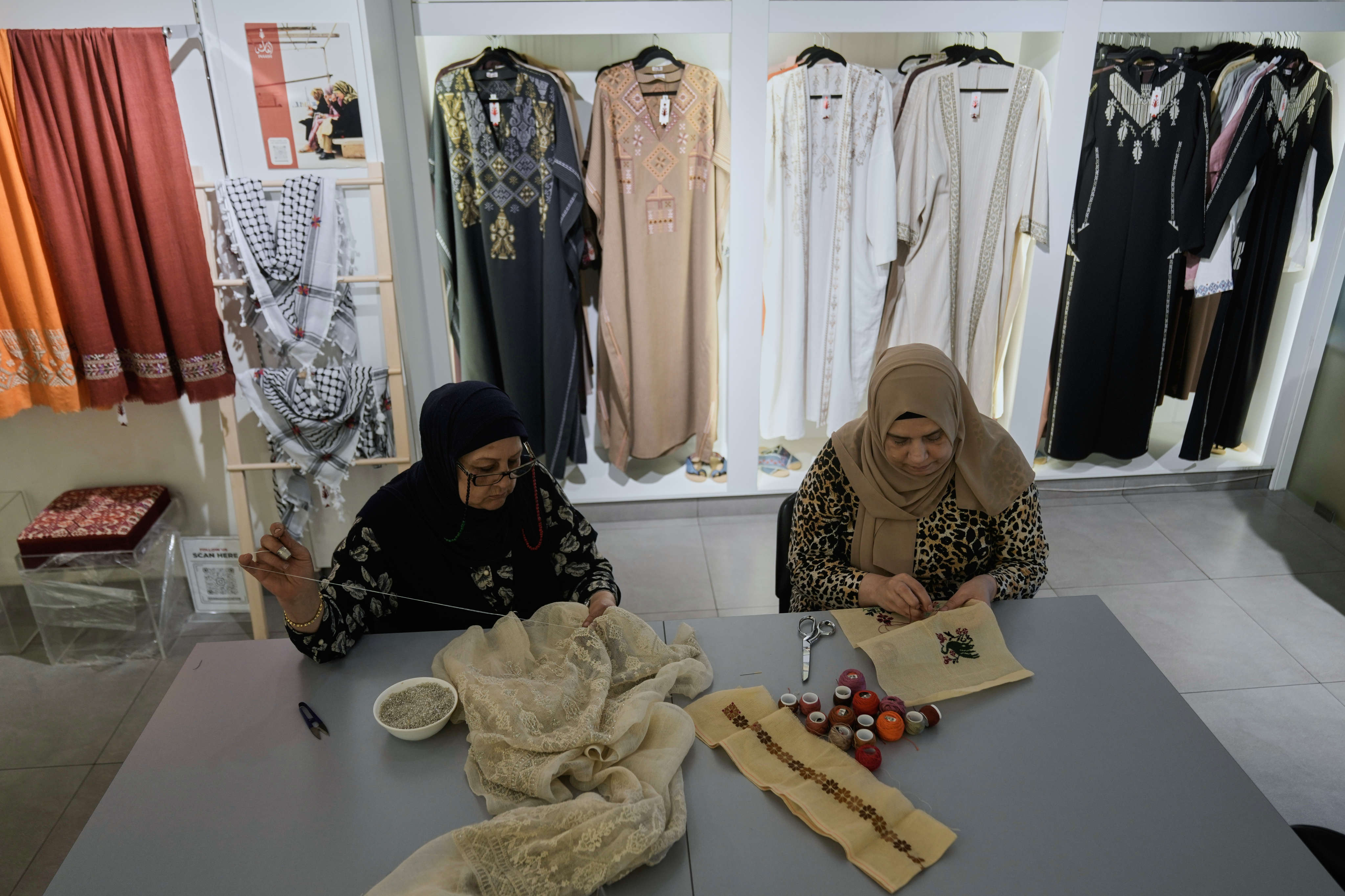 Palestinian weavers Rula Barakeh (right) and Samira Nasser work on handmade embroidered pieces at the Inaash Association embroidery workshop in Beirut, Lebanon. Photo: AP