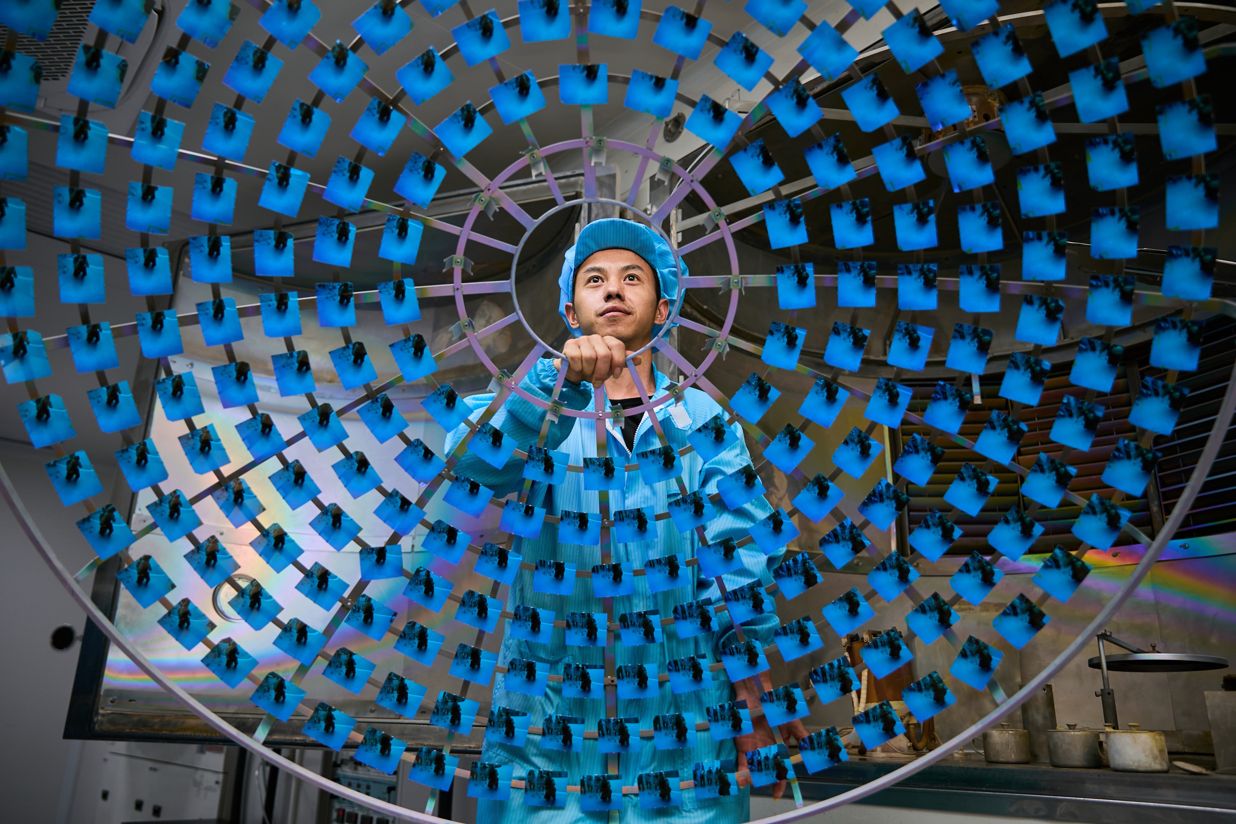 A worker coats eyeglass lenses, on June 6, in Wenzhou, Zhejiang province. Photo: VCG via Getty Images