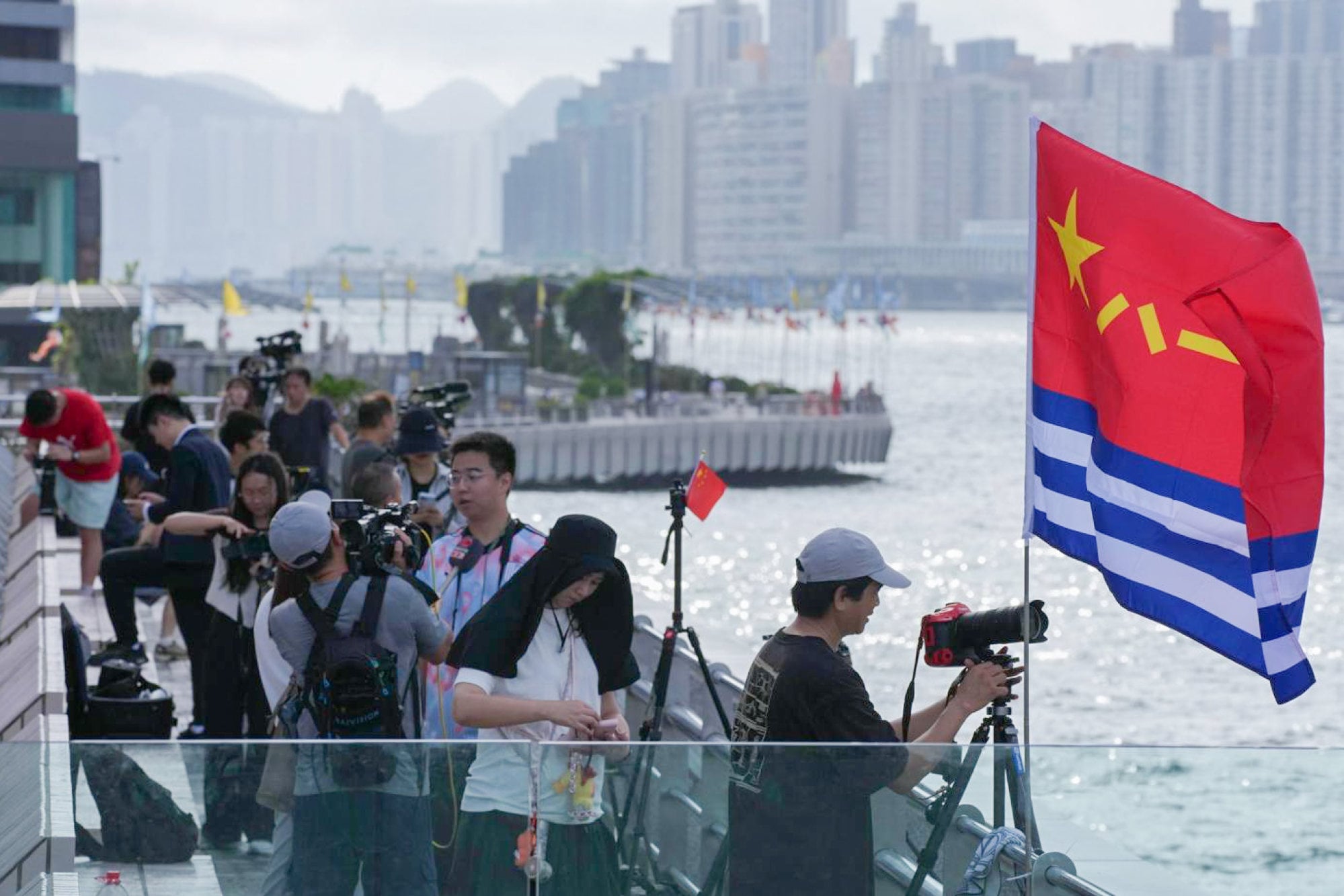 Residents and the media at the Cultural Centre observation deck in Tsim Sha Tsui capturing shots of the approaching PLA vessels. Photo: Jelly Tse