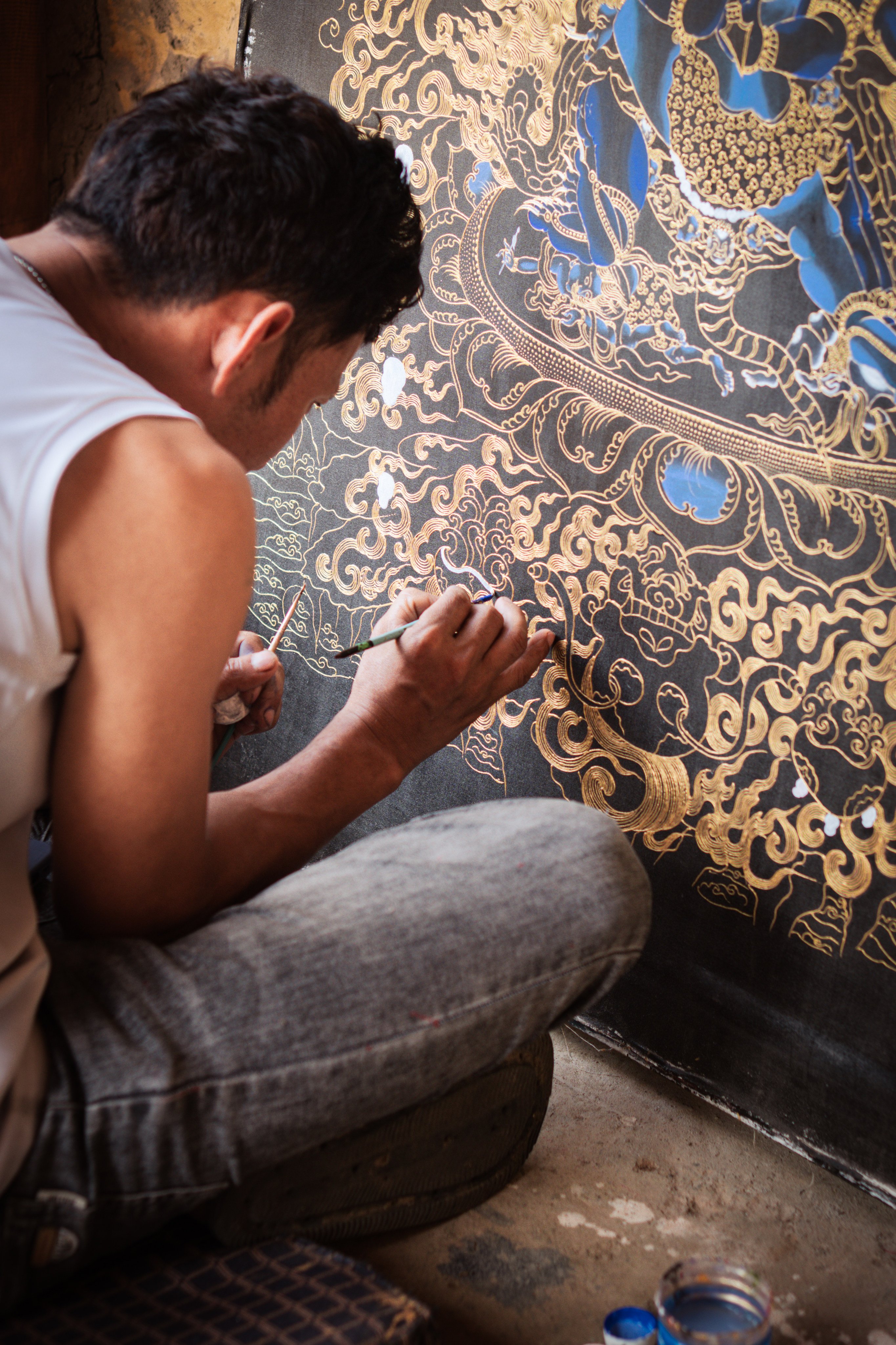 Kinley Tshering paints a thangka of Vajrakilaya, a wrathful deity of Vajrayana Buddhism, Bhutan’s state religion, at the Exotic Art Gallery, in Punakha district, Bhutan. Photo: Jen Paolini