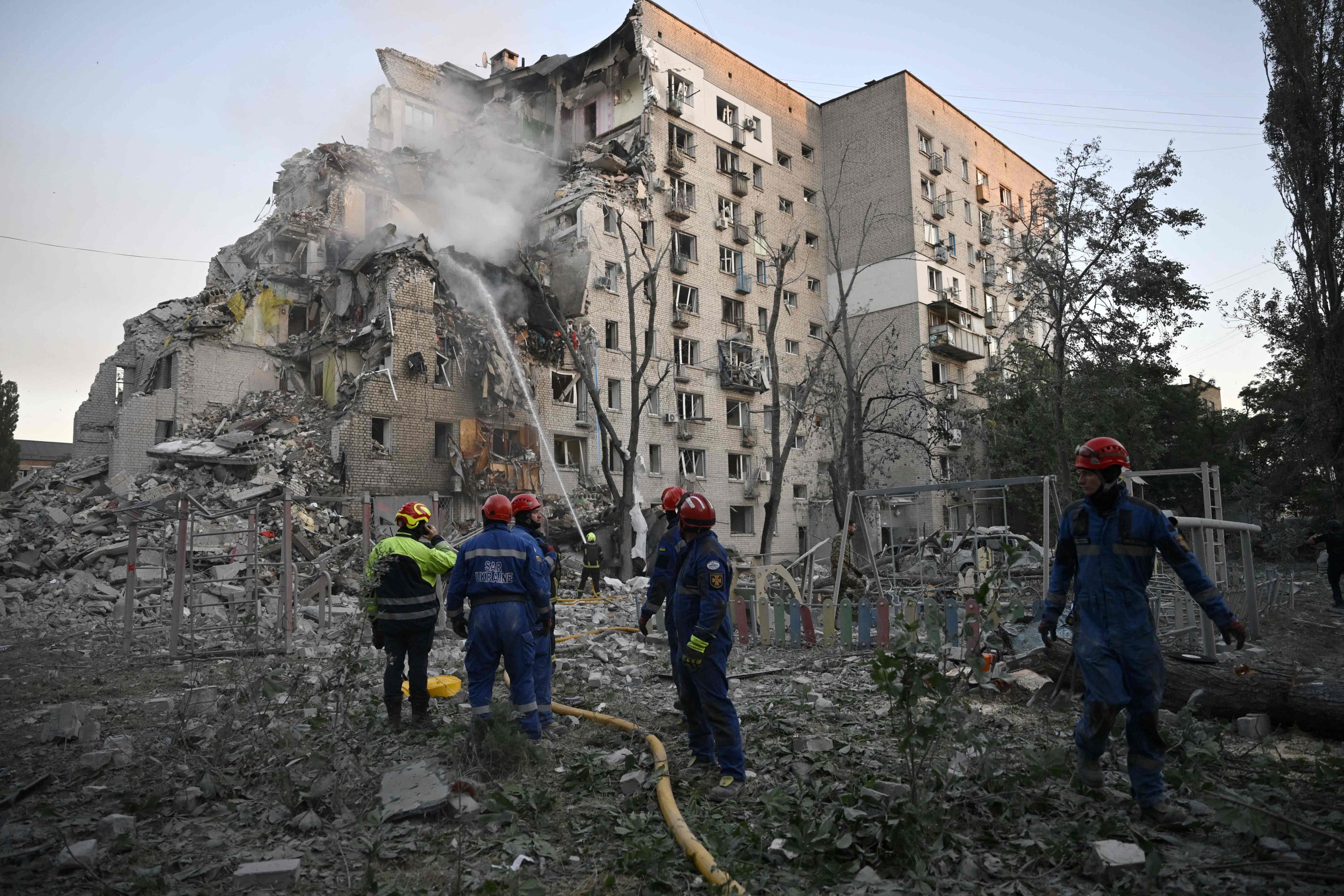 Extensive damage to a residential block, with a chunk of the building missing. Photo: AFP