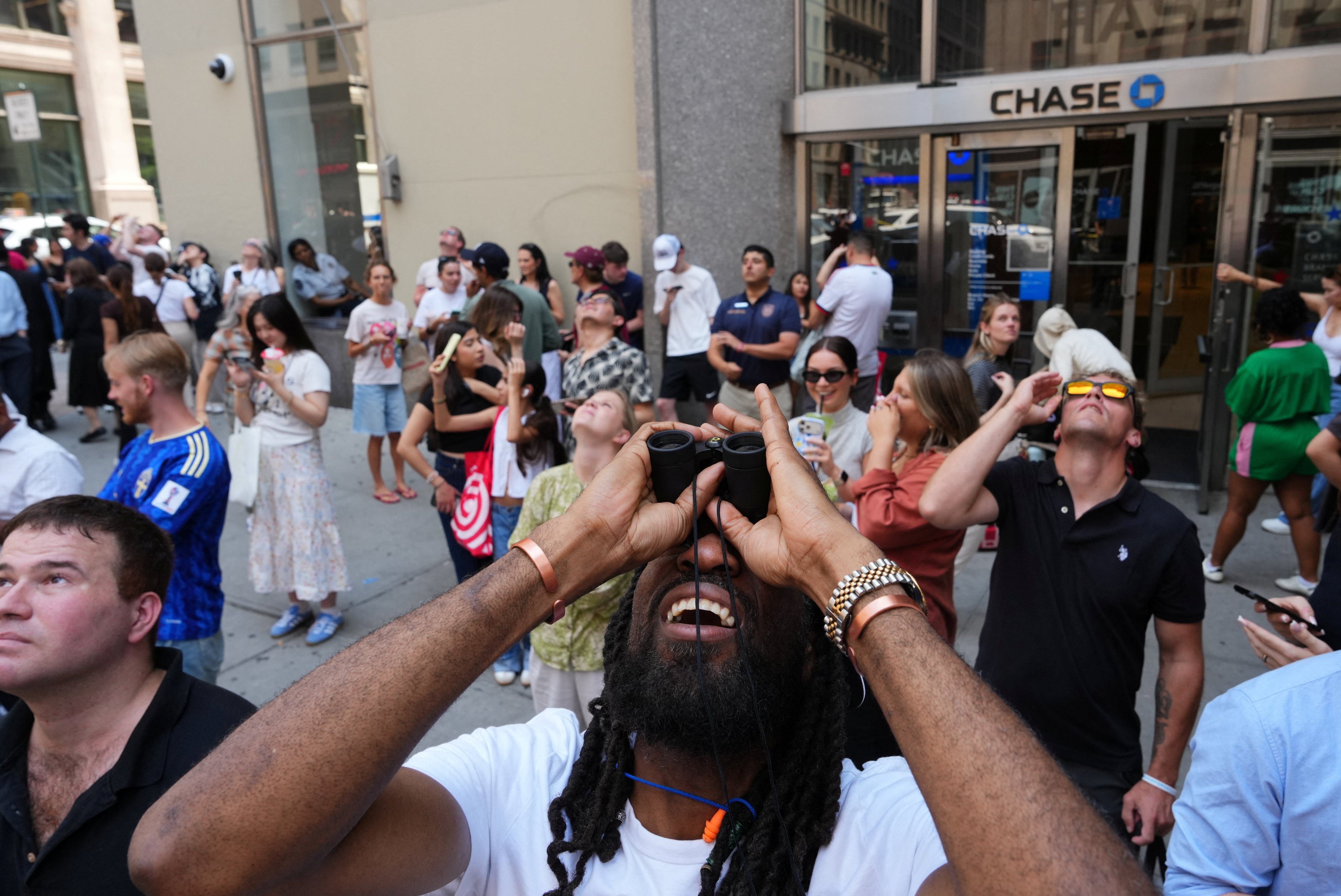 People look up at the climbers. Photo: Reuters
