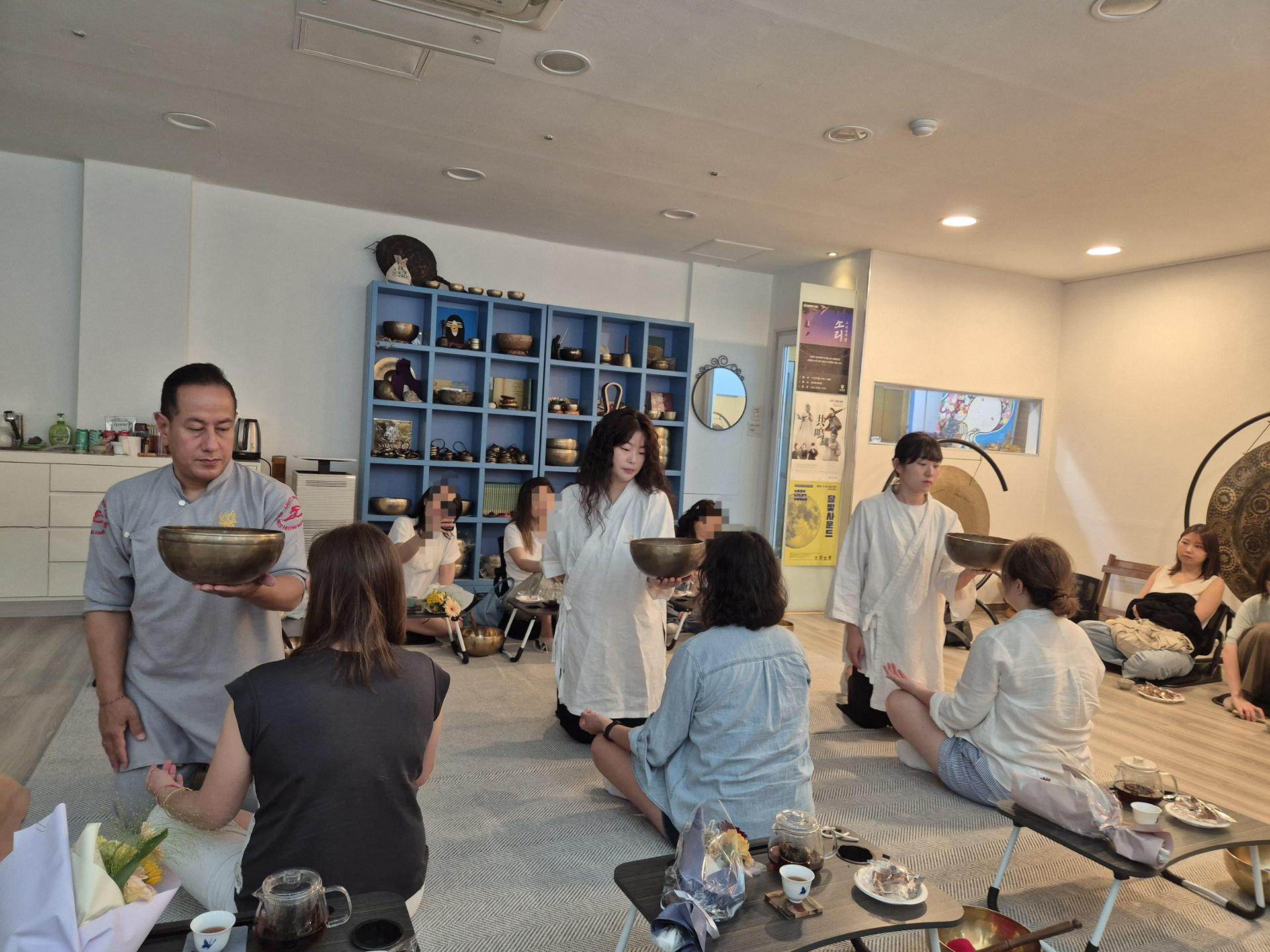 Tourists try singing-bowl meditation at the Saraswati Meditation Centre in Seoul's Gangnam district. Photo: The Korea Times