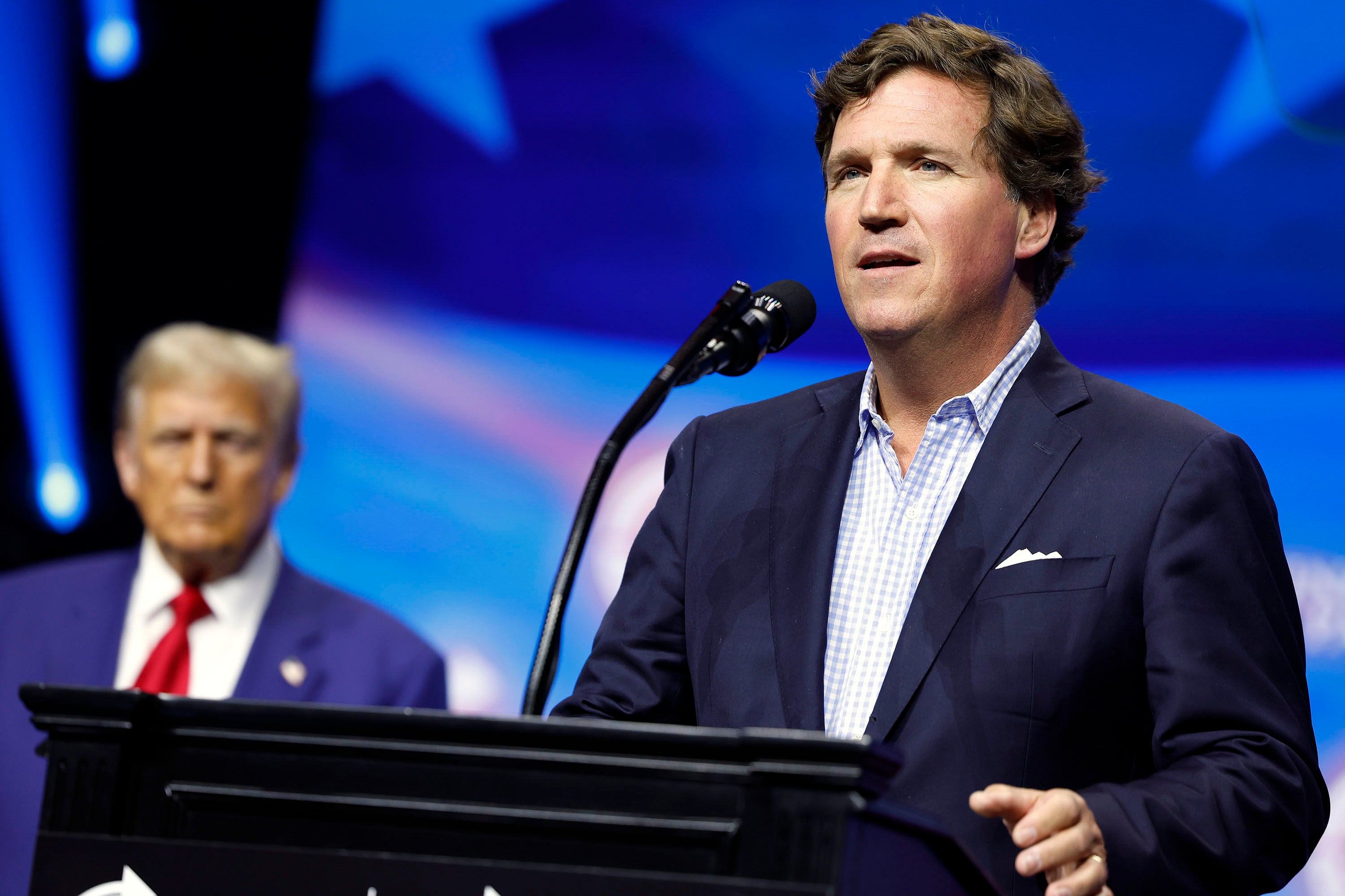 Political commentator Tucker Carlson speaks alongside then Republican presidential nominee Donald Trump during a rally on in October 2024 in Georgia. President Trump’s handling of the Iran war and the economy continue to divide the conservative movement. Photo: TNS