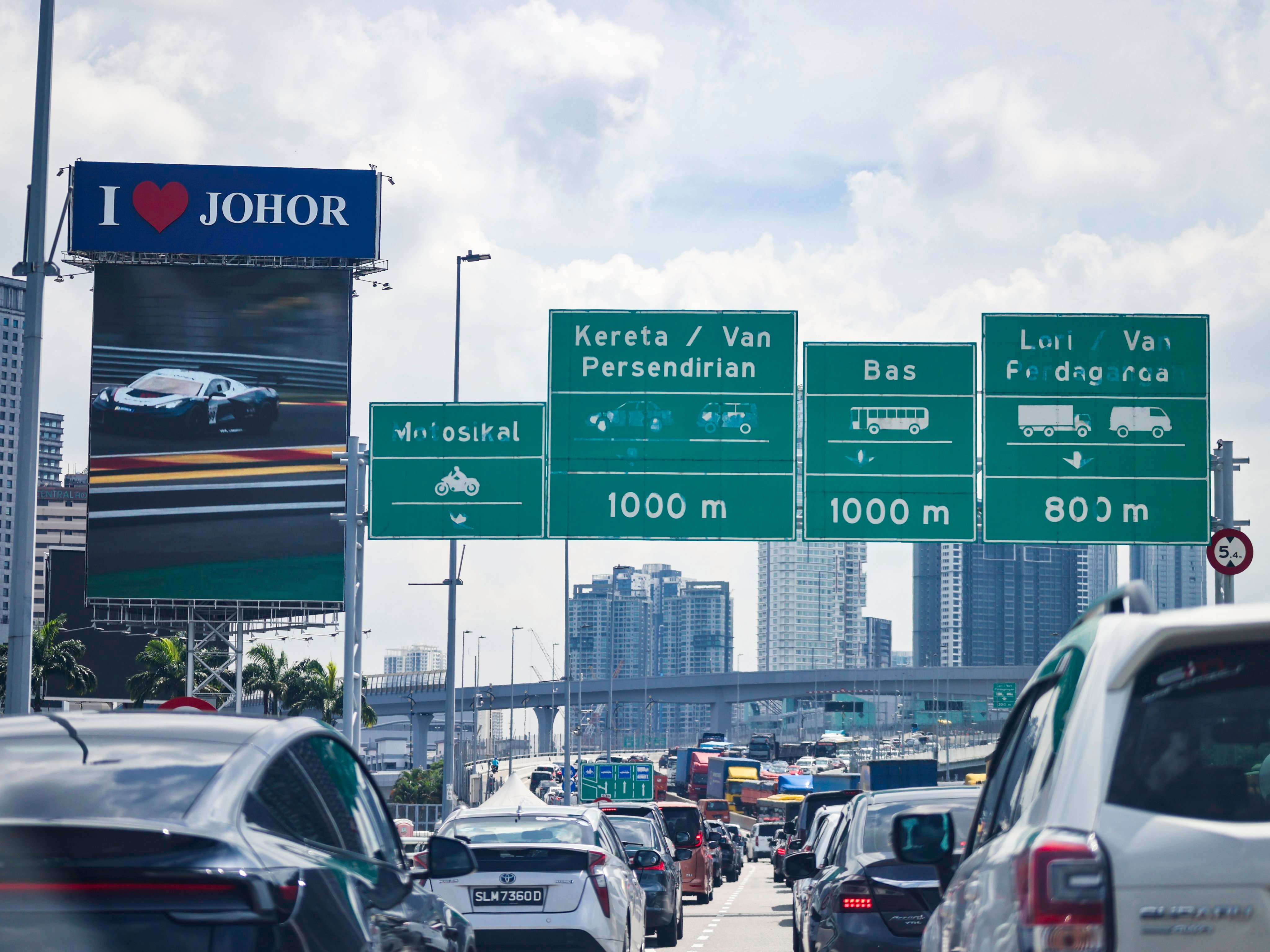 Vehicles are in Malaysia’s southern Johor state just after passing the causeway from Singapore. Photo: Shutterstock