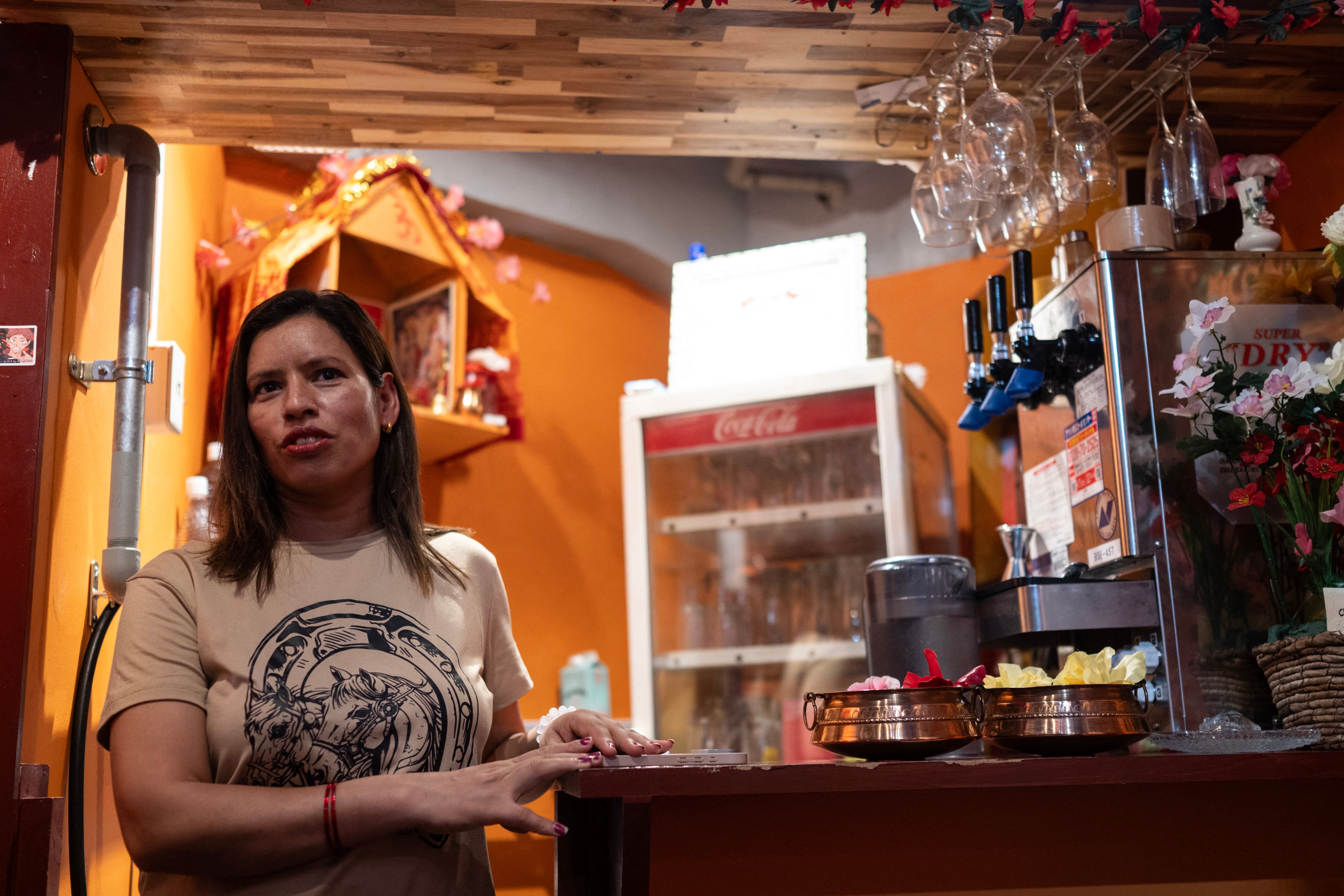 Budhathoki Samjhana, a restaurant owner and business manager visa holder at Chitwan Rhino Restaurant and Bar, looks on inside her bar in the Okubo district, one stop north of Shinjuku, in Tokyo on June 12, 2026, a neighbourhood known for its large immigrant communities, including Korean, Southeast Asian and South Asian residents. Authorities late last year toughened requirements for business manager visas after reports many foreigners -- chiefly Chinese nationals -- were setting up shell companies to move to Japan. (Photo by Andrew CABALLERO-REYNOLDS / AFP) / TO GO WITH STORY: Japan-politics-immigration, FOCUS by Kyoko HASEGAWA