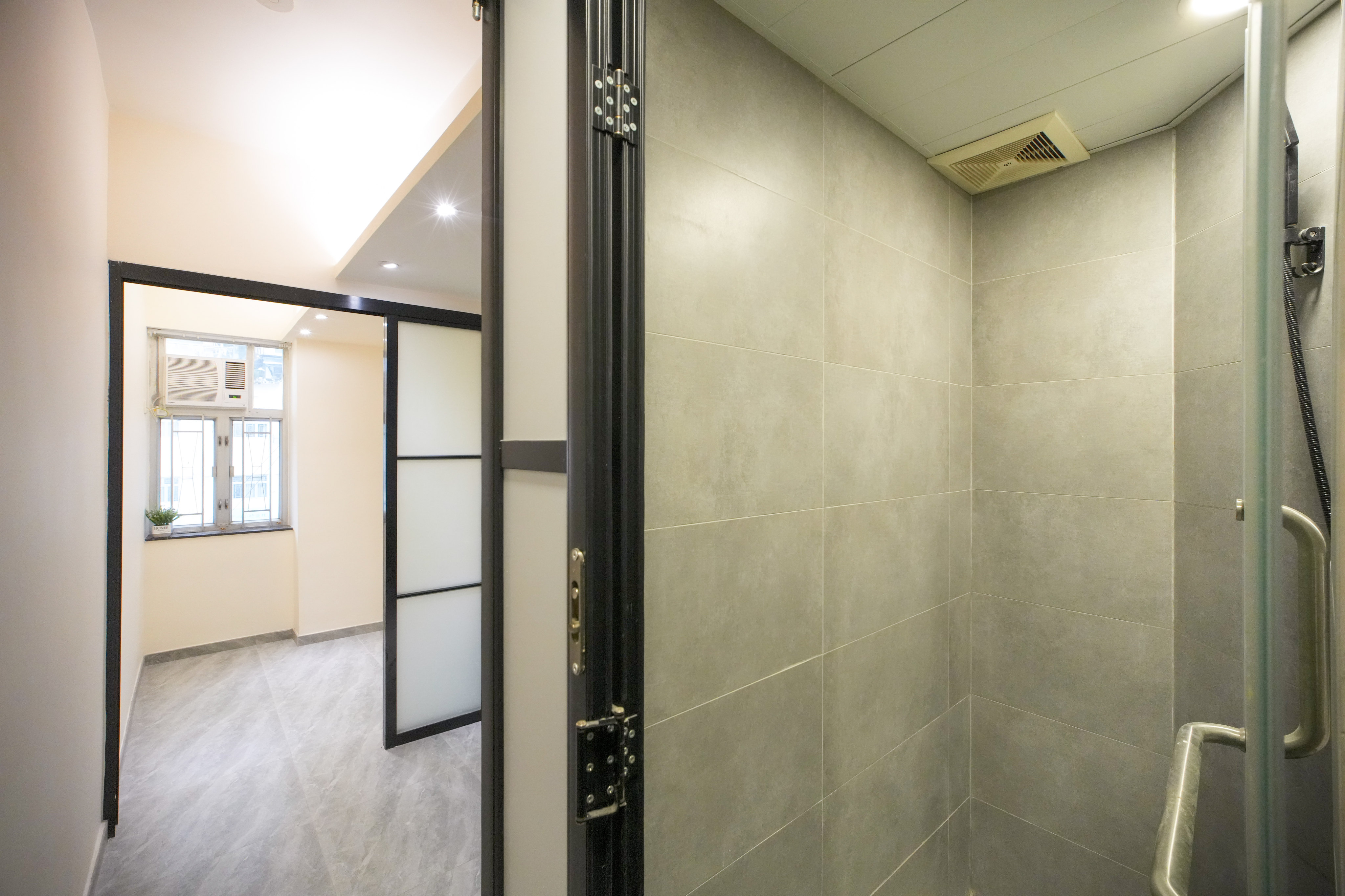 Interior view of a certified basic housing unit meeting minimum standards, including ventilation and fire safety, at Tsung Nga Building in Sham Shui Po. Photo: Dickson Lee